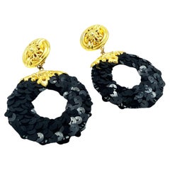 CLIP-ON EARRING BY KALINGER PARIS, black pailletts disk with gold plated metal