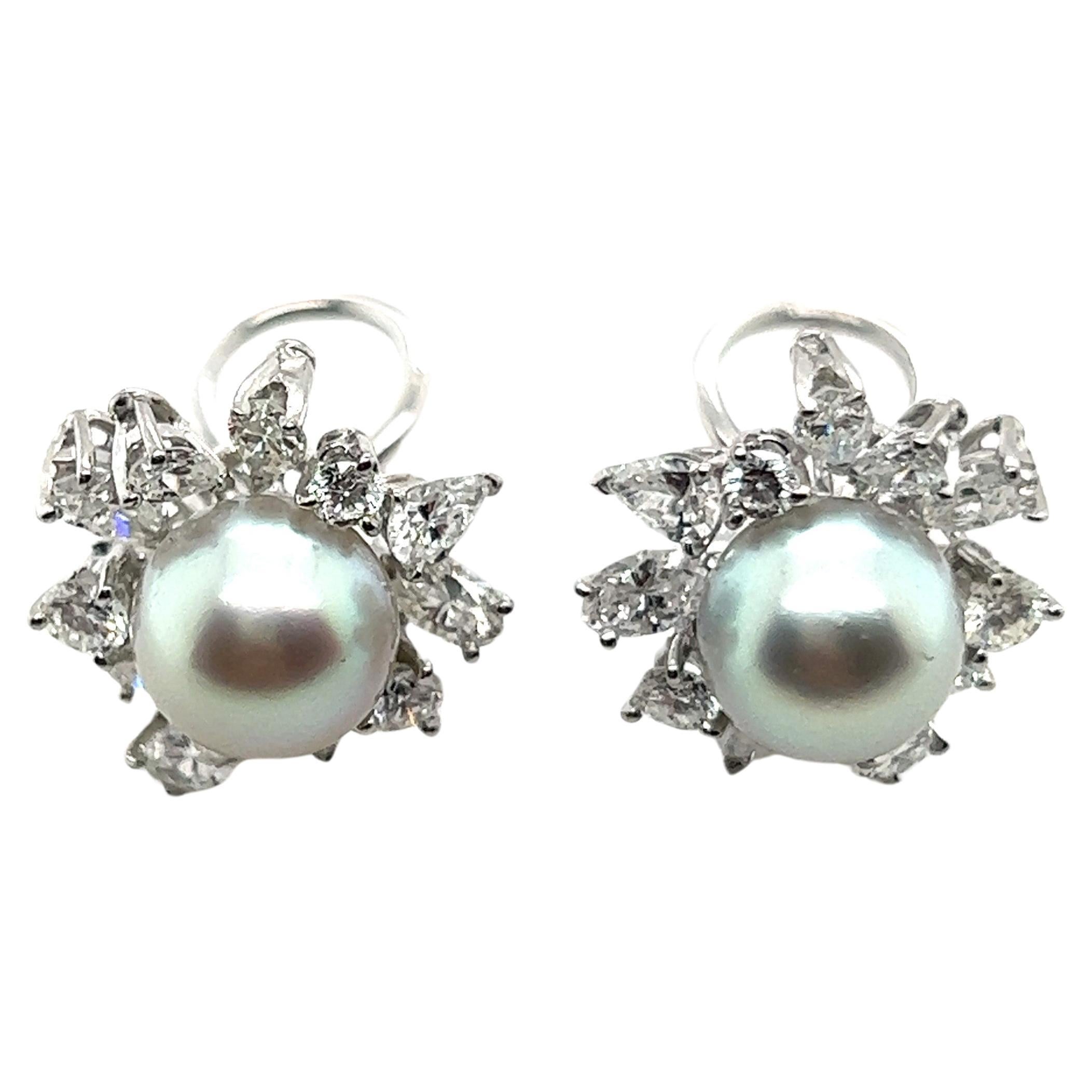 Exquisite pair of earrings resembling delicate flowers with pearls and diamonds by Meister Jeweler. 

Crafted from lustrous 18 Karat white gold, these earrings feature two Akoya pearls, each measuring 8.8 mm in diameter, serving as the captivating