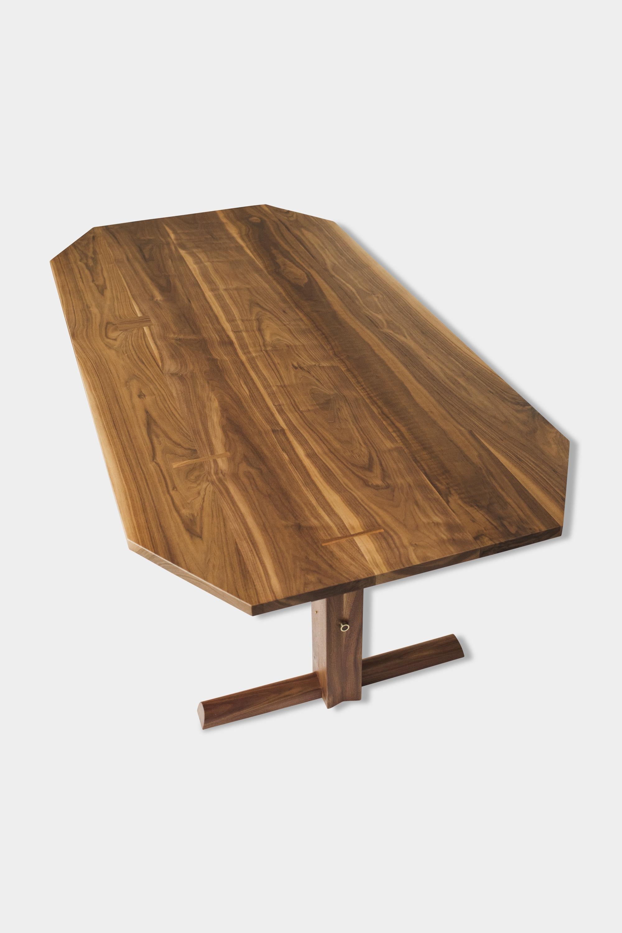 Handmade dining table with a double-ship mast inspired trestle base. Solid wood tops feature clipped corners and individualized dutchman joints. Each table uniquely accentuates and utilizes the natural characteristics of the lumber we source. This