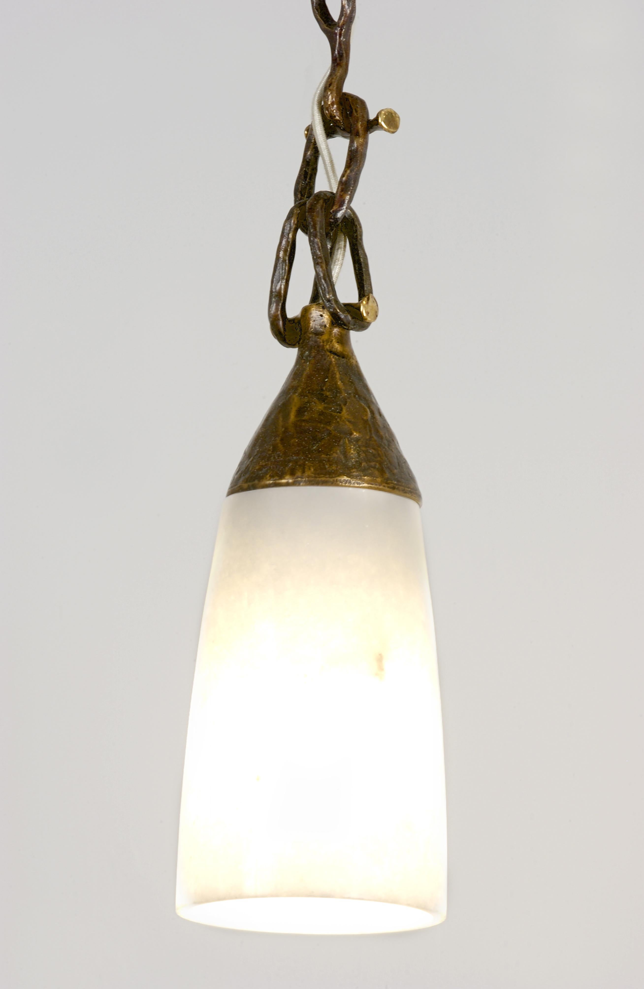Inspired by the translucent white marble in India, Stephanie Odegard decided to backlight a delicately carved hanging cone to create an elegant and sophisticated statement in light and stone.
 
Cloche Pendant
Size-  06” x 06” x 14” H
Materials -