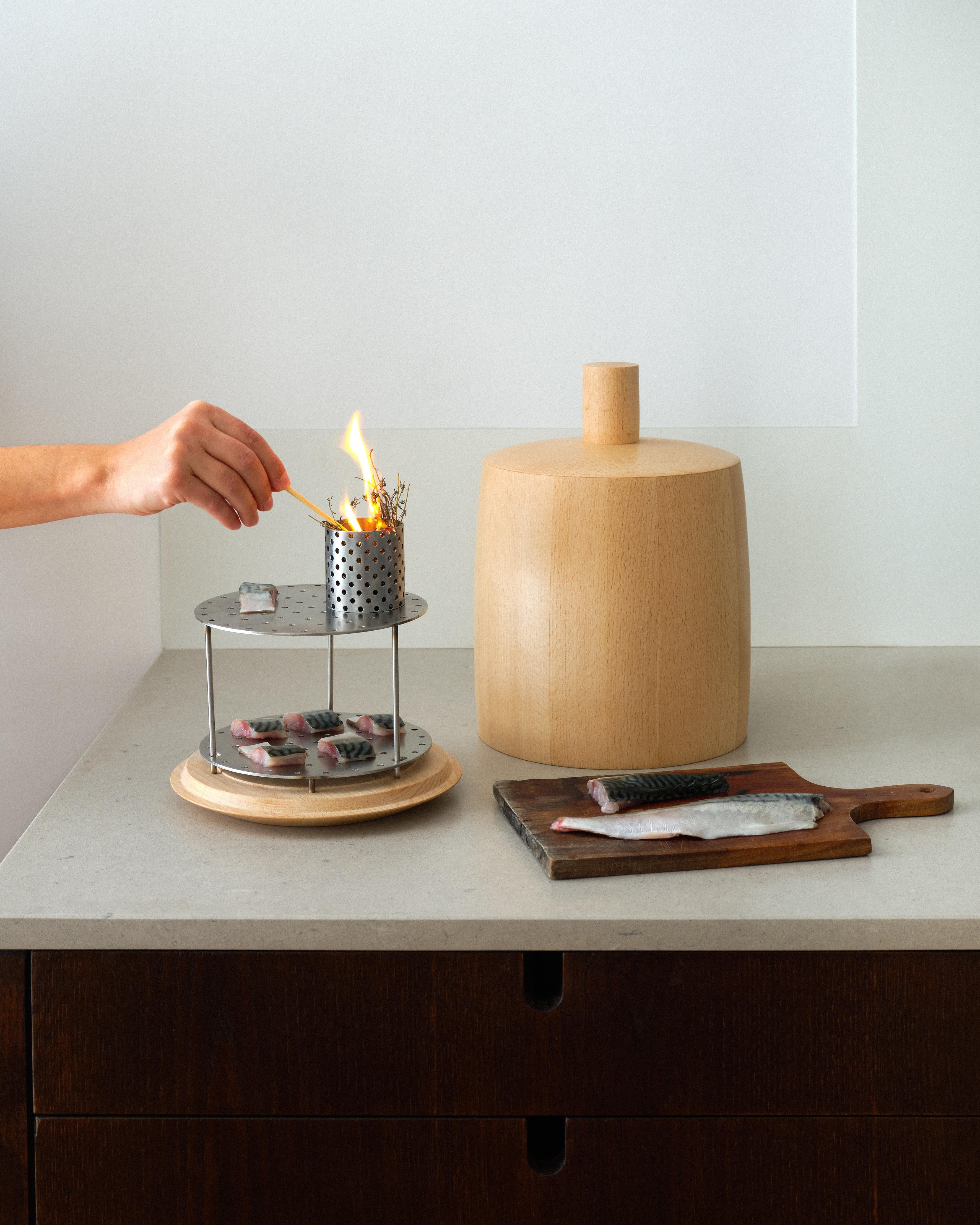 CLOCHE is a table smoker designed by designer Guillaume Bloget for cold smoking food from aromatic plants or wood chips. It preserves the flavors intrinsic to each food while flavoring them with a smoky note. 

The smokehouse becomes both a