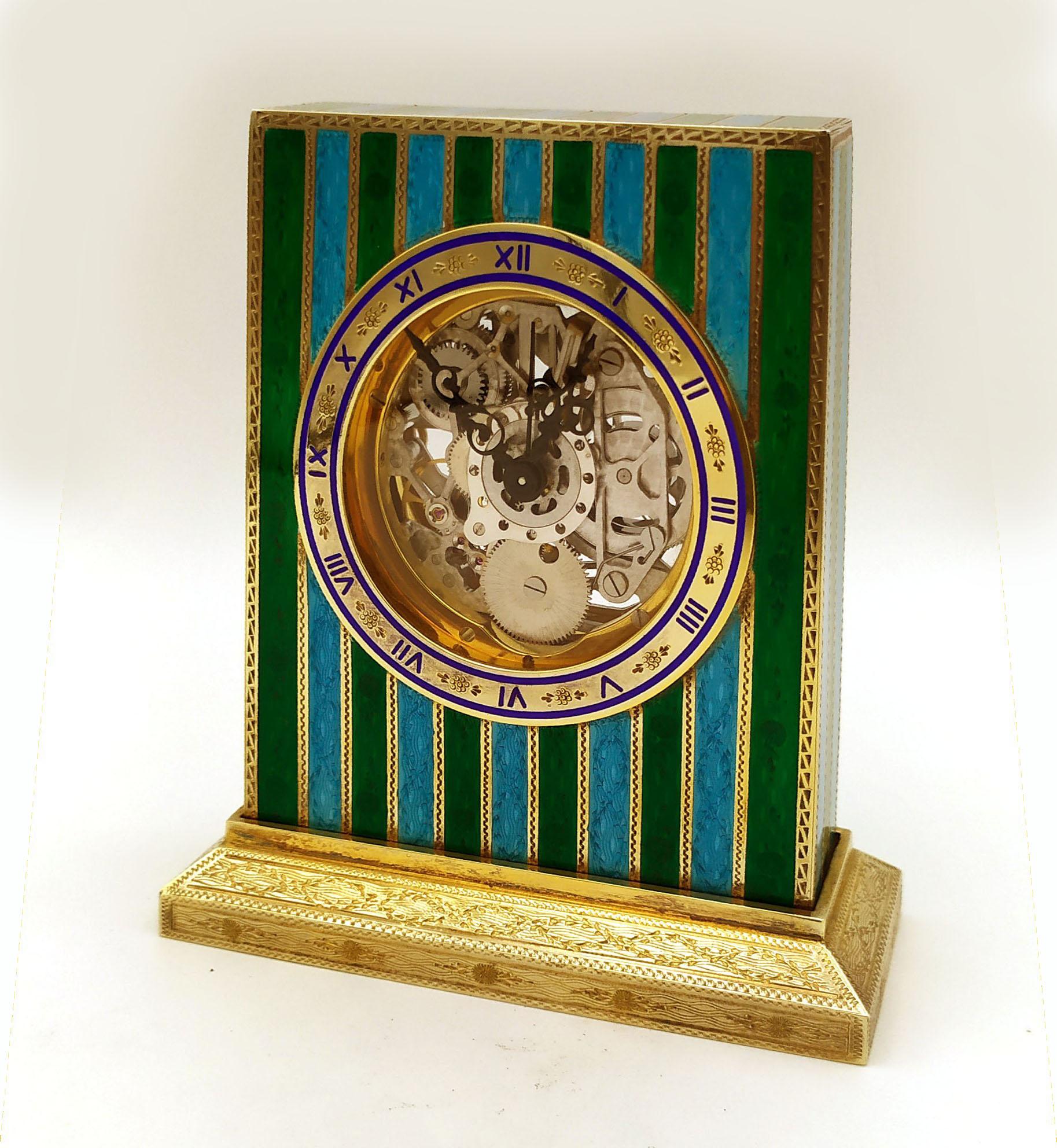 Table set made up of a clock and 2 candlesticks in 925/1000 sterling silver gold plated with two-tone translucent stripes fire-enamelled on guillochè and fine hand-engravings.
The clock has a base of cm. 4.5 x 10 and is rectangular cm. 8.3 x 10.2 x