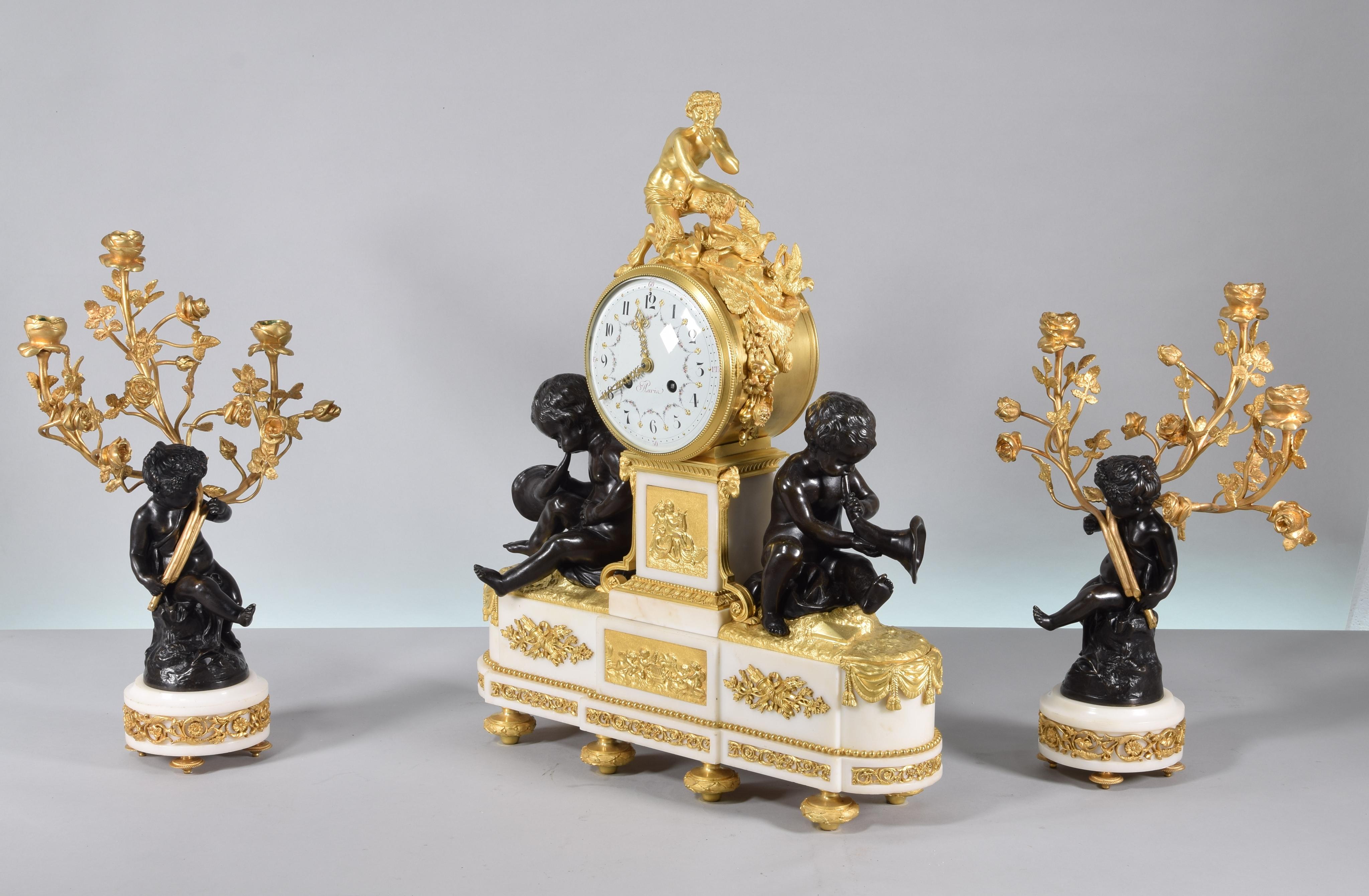 Clock and candelabra trim. Blued and gilded bronze, marble. Raingo Frères, Aaria, Clodion. Paris, France, second half of the 19th century. 
Working. 
The two candelabras follow a model highly appreciated in the 19th century of a bronze figure of a