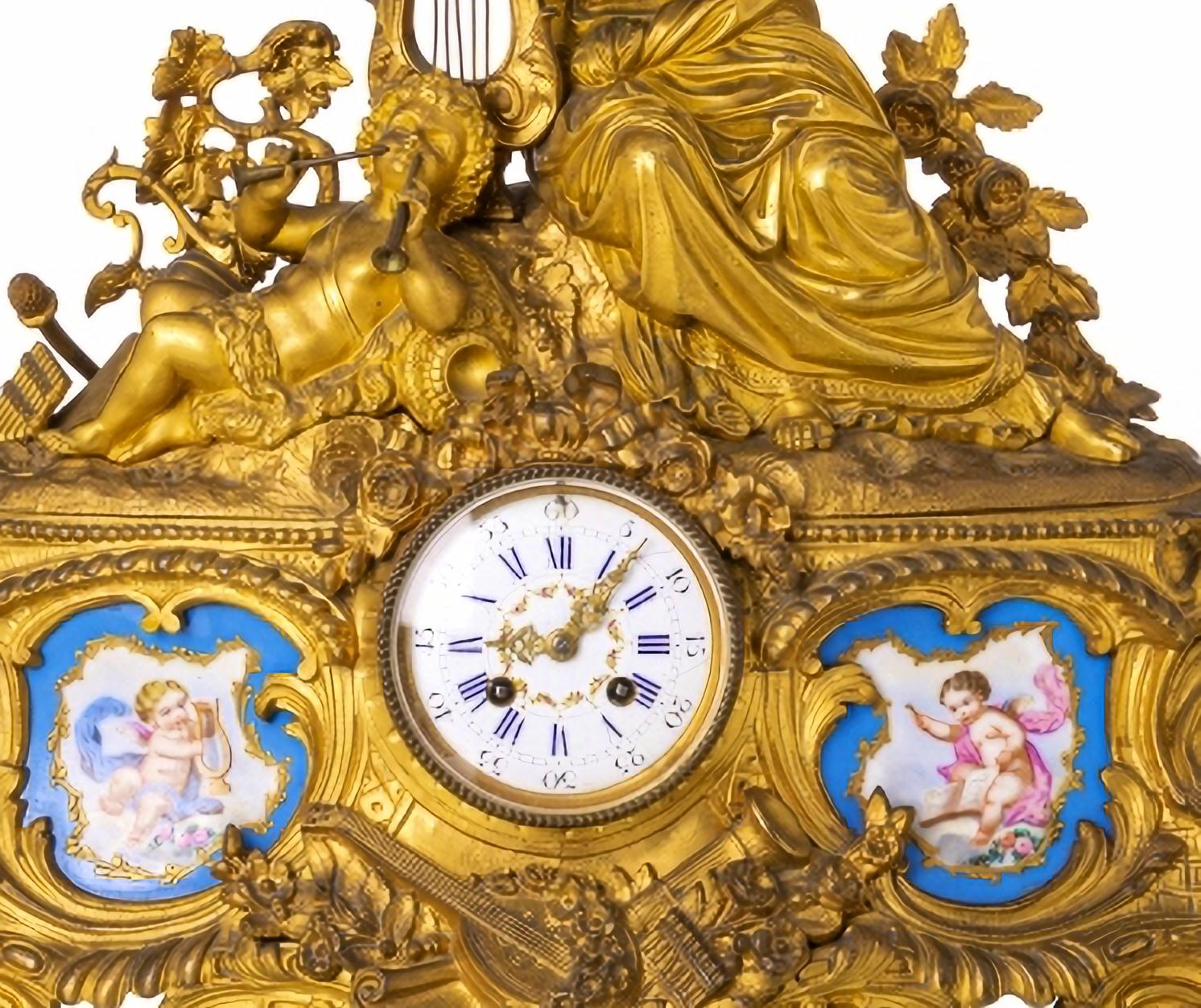 CLOCK AND PAIR OF CANDLESTICKS

French
19th Century
Napoleon III,
in relief and gilt bronze, allegory to music, with painted porcelain plaques, by Sévres.
Enamelled dial with black Roman and Arabic numerals, eight-day autonomy, strikes hours