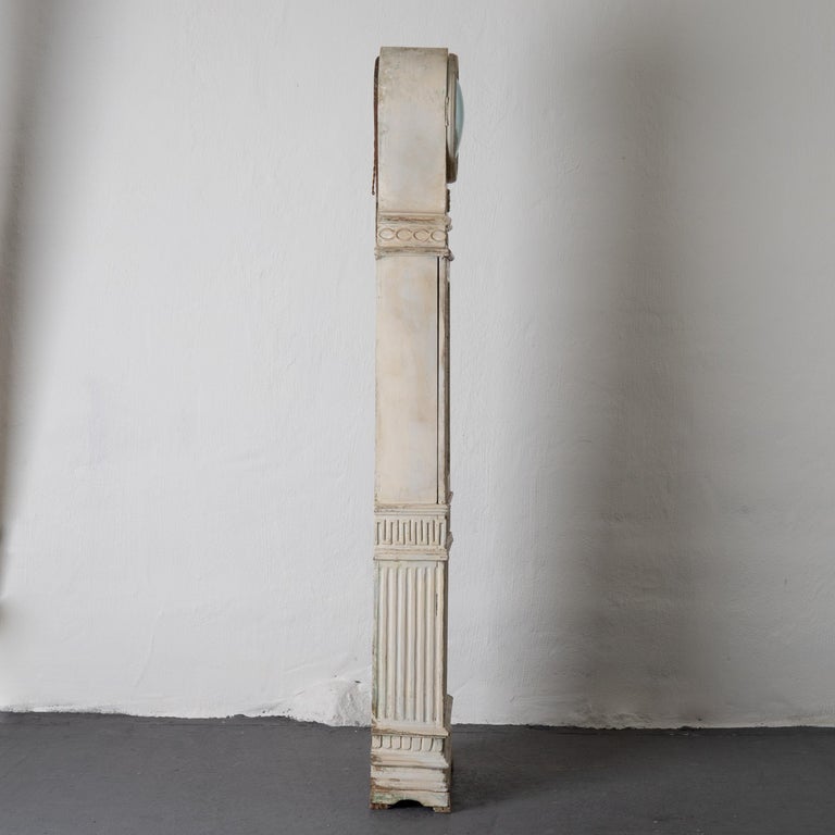 A floor clock made during the Gustavian period 1790-1810 in Sweden. Re-touched white paint. Decorated with Gustavian details such as channels and ribbons. Finial on top replaced. 


       