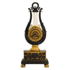 Orologio in bronzo dorato e patinato