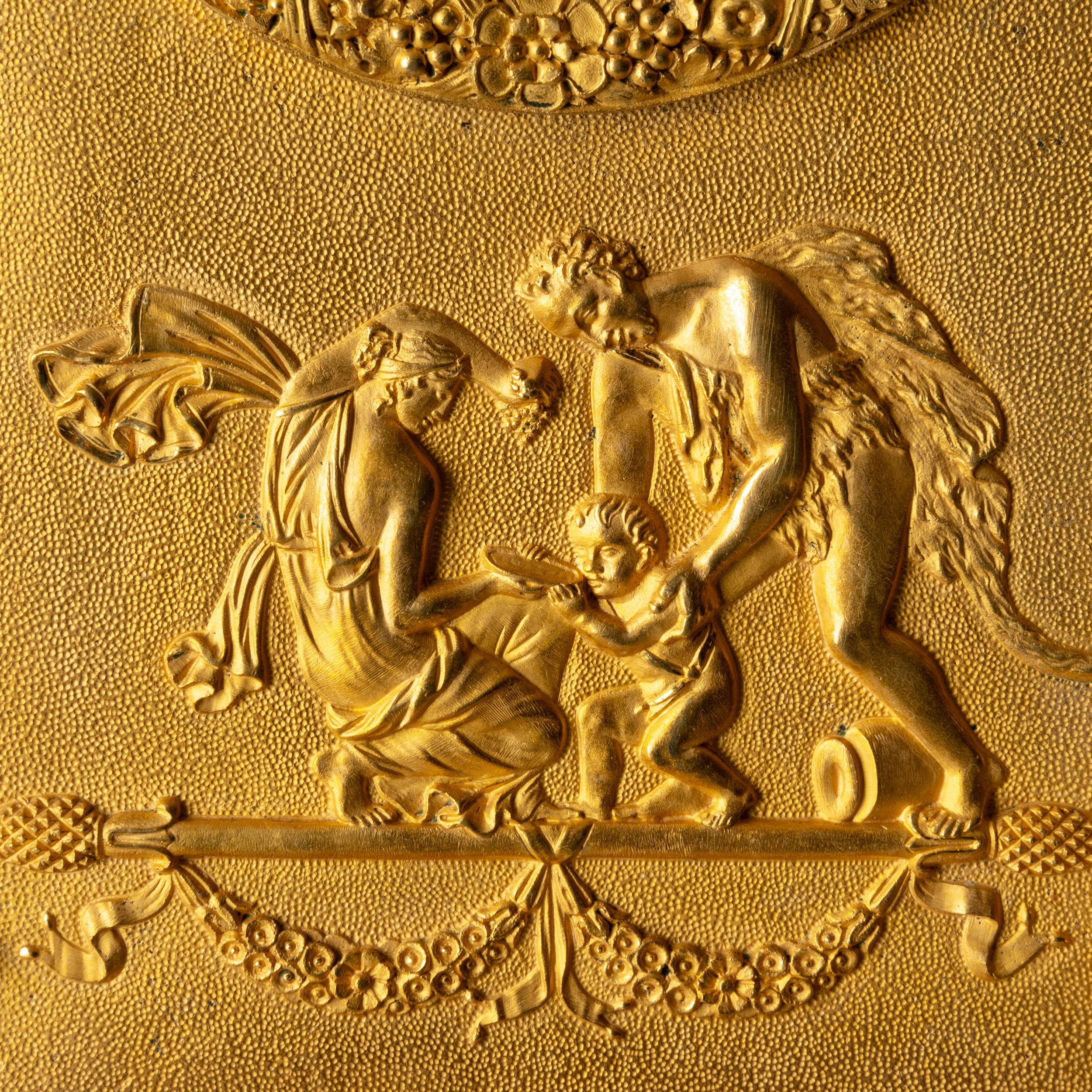 Table pendulum clock made in France during the empire period, 1790-1810. Made from gilt bronze. Depicting a man holding a cornucopia. 