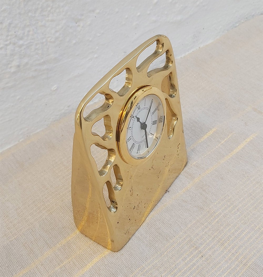 The decorative Perforated Clock was created by David Marshall, it is made of sand cast brass.
Handmade, mounted and finished in our foundry and workshop in Spain from recycled materials.
Certified authentic by the Artist David Marshall with his