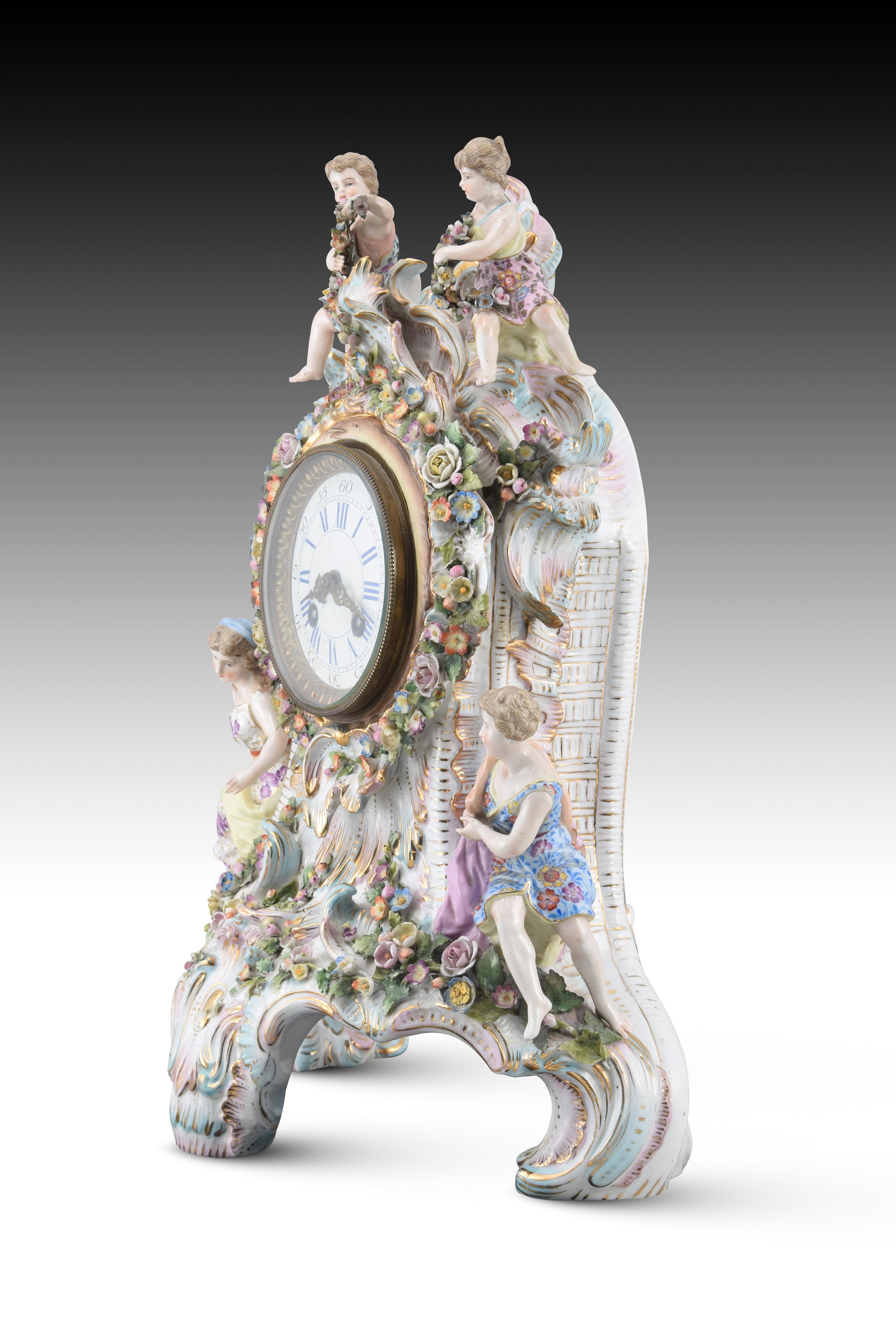 Clock. Porcelain, metal, glass. Lenzkirch, Germany, late 19th century. 
Has damage, figure arm. 
Table clock with Lenzkirch marked machinery, white dial with Roman numerals for the hours and Arabic numerals every five for the minutes. The