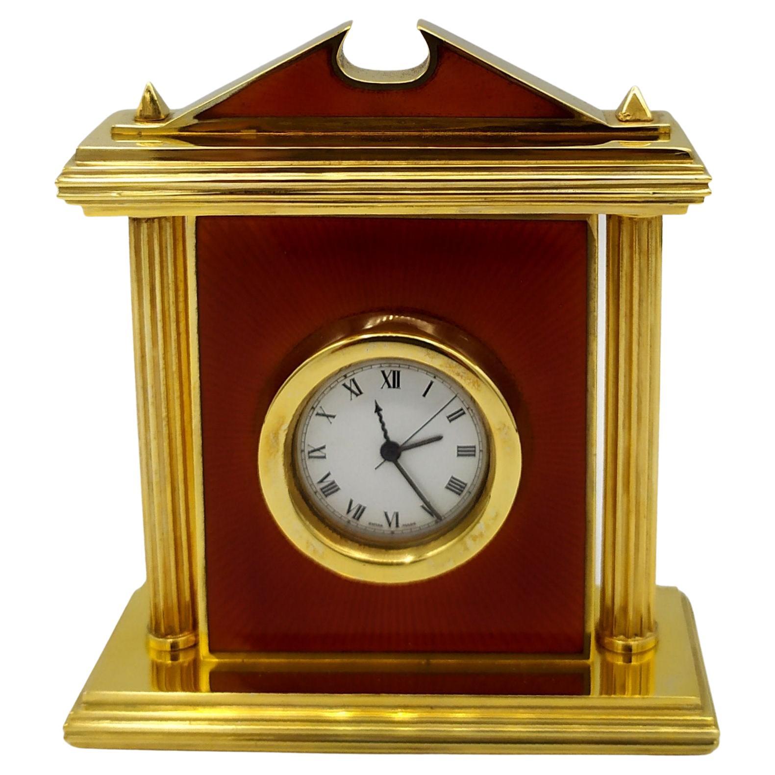 Clock Red fired enamel on guillochè, with columns in Neoclassico Salimbeni. Small gold-plated 925/1000 sterling silver table clock with translucent fired enamel on guillochè, with columns in neo-classical Hellenic style. Swiss mechanical movement