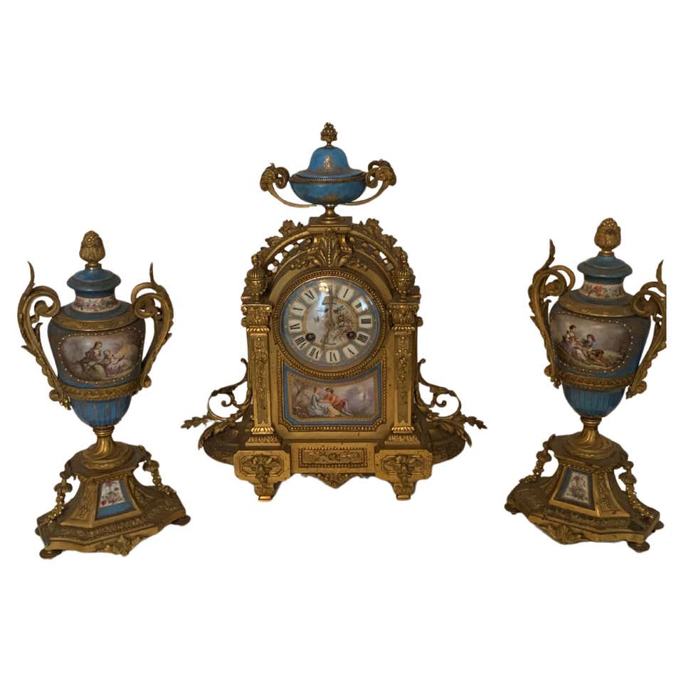 palatial 3 pieces clock set in bronze with cherub For Sale at 1stDibs
