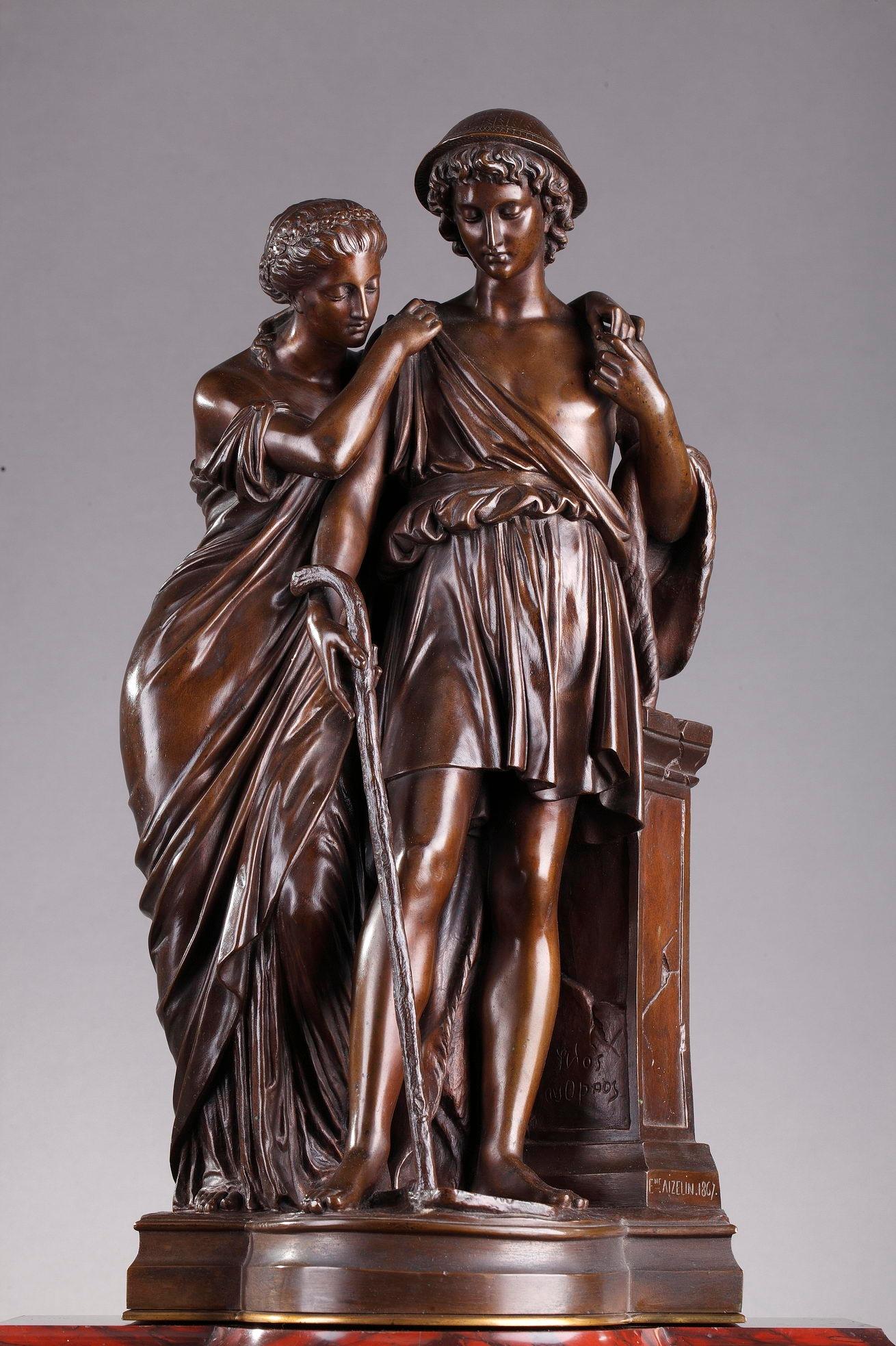 Red Griotte mantel (fireplace) clock decorated with a patinated bronze group, Les bergers d'Arcadie (Shepherds of Arcadia) by Eugene-Antoine Aizelin (1821-1902), featuring a maiden and a shepherd mourning at a tomb. The woman is wearing a flowing