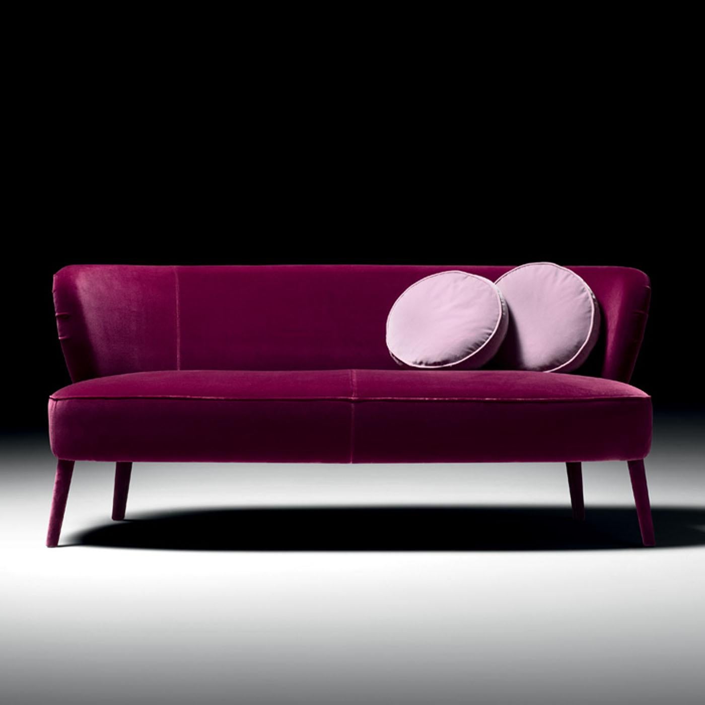 Perfect piece for adding a pop of color to otherwise dull contemporary decors, this sofa couples the sturdiness of a clean-lined beech frame with the glamour of a vibrant orchid-purple fabric upholstery. The backrest's slightly curved sides distill