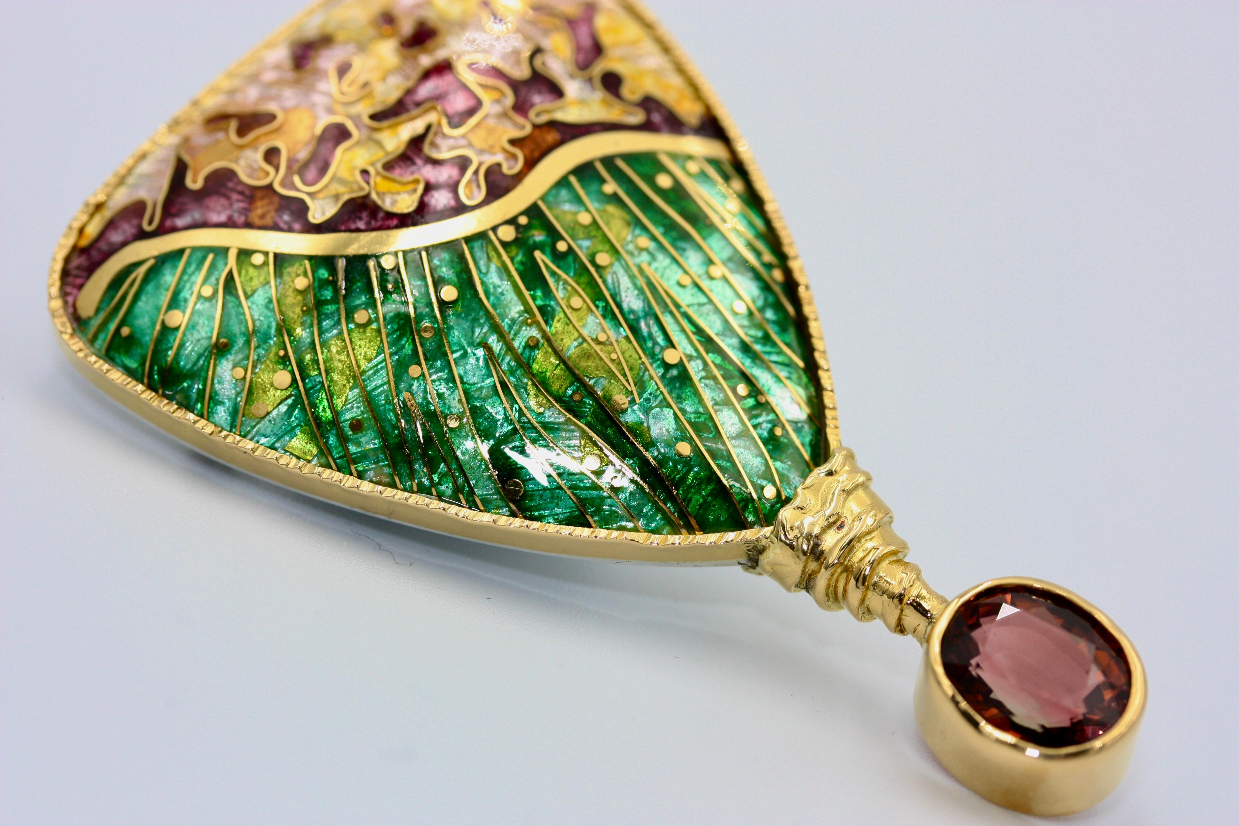 A unique brooch in Cloisonne Enamel which is embellished with a 5.4ct. Tourmeline. Completely hand-made ;is is also hand signed on the back of the actual enamel piece and is inlaid with 24K Gold. The bezel is in 22K gold, while the back is in