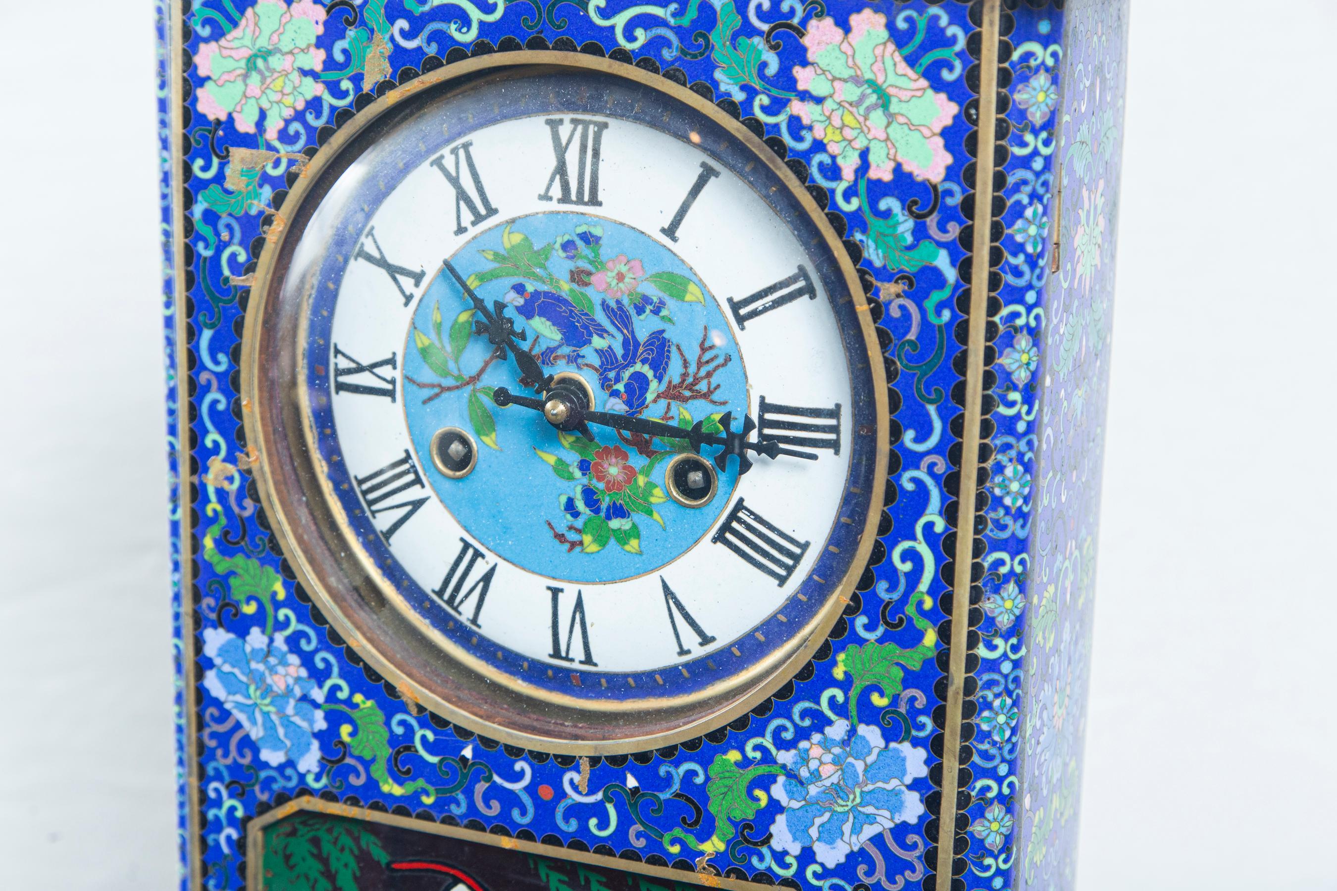 Blue ground covered entirely in flowers, vines and geometrics. Painted face behind glass. Painted window in front of the pendulum. The back is of wood and would 2 keys to open. The left side of the body is closed with a hook and eye that does open.