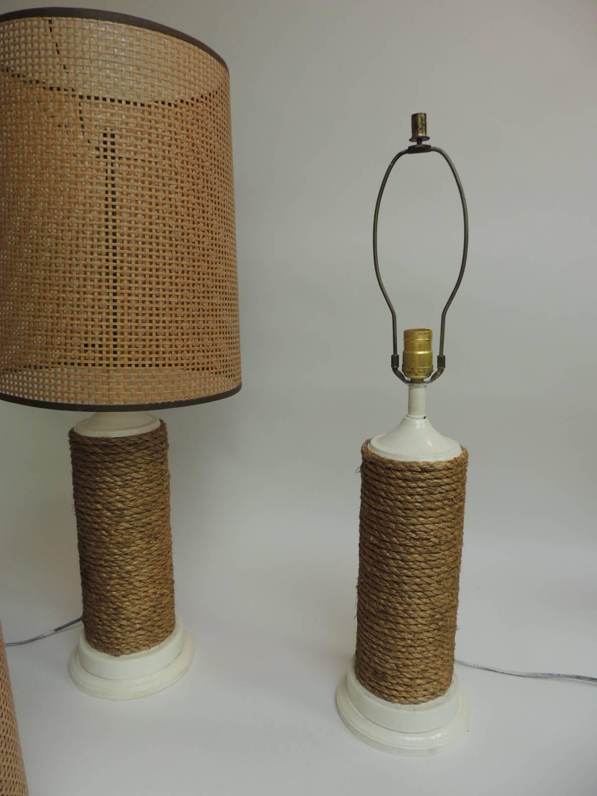Nautical lamps wrapped in twine rope over wood, round painted wood bases, brass fittings,
Original woven shades (in excellent conditions) and harps.
Size: to harp 28 H - to socket 19 H x 6 D
Shades sizes: 11 x 11 x 15 H
High to shade on lamp: 31.
 
