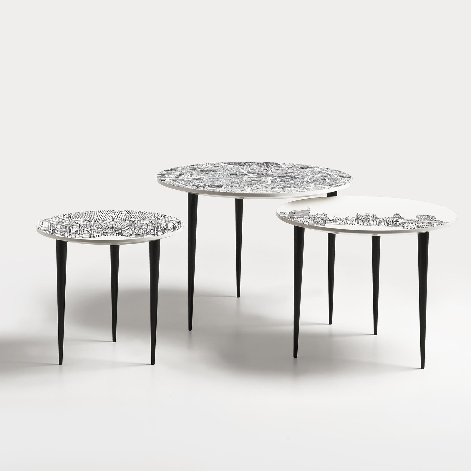Designed by Anna Sutor for Extroverso, these exclusive nesting tables are made of wood with a glossy finish and feature black conical legs with white round tops accented with printed illustrations of the iconic urban landscapes of Milan from three