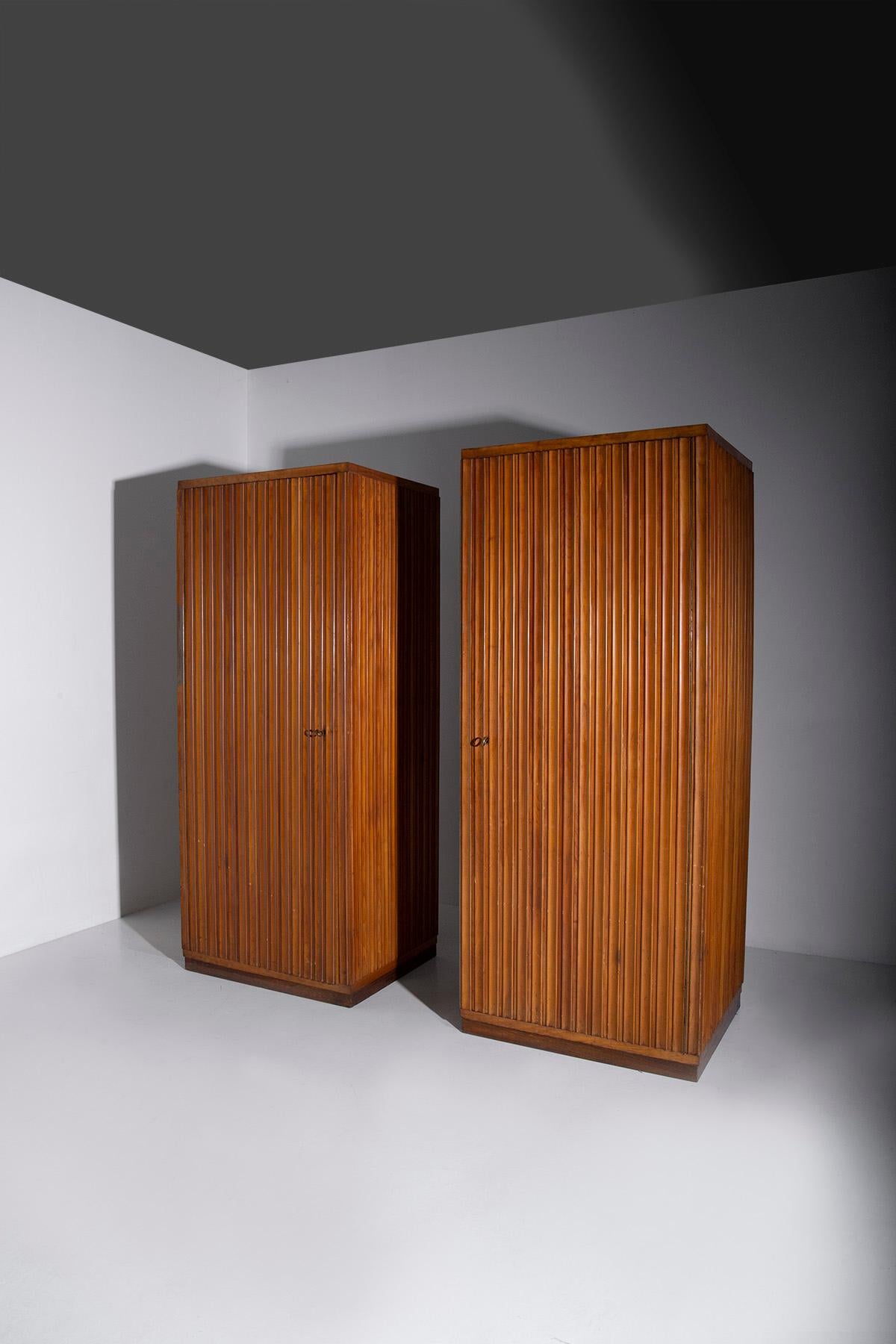 In the enchanting era of the 1950s, Italian craftsmanship reached its zenith, and the Elegant Grissinato Closets by Fabbrica Mobili e Armadi Triestina, attributed to the skilled hands of Luigi Scremin, stand as timeless testaments to that glorious