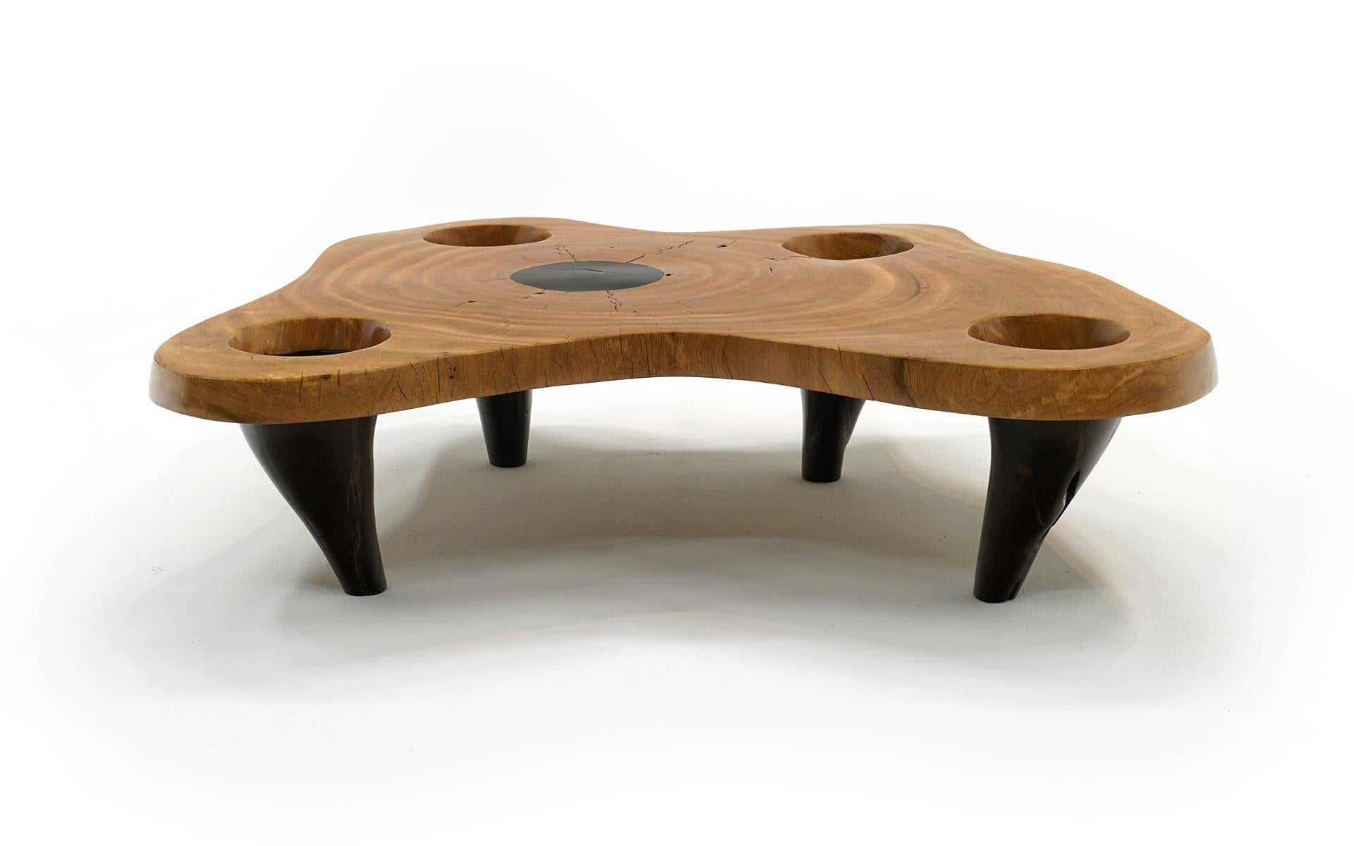 Wonderful organic modern cloud shaped coffee table by Hugo Franca, Brazil.  The 2.5 inch thick top is of a single piece Imbula and legs of Ipe, both exotic woods.  Five round insets in the top.  The table is in very good condition and made of solid