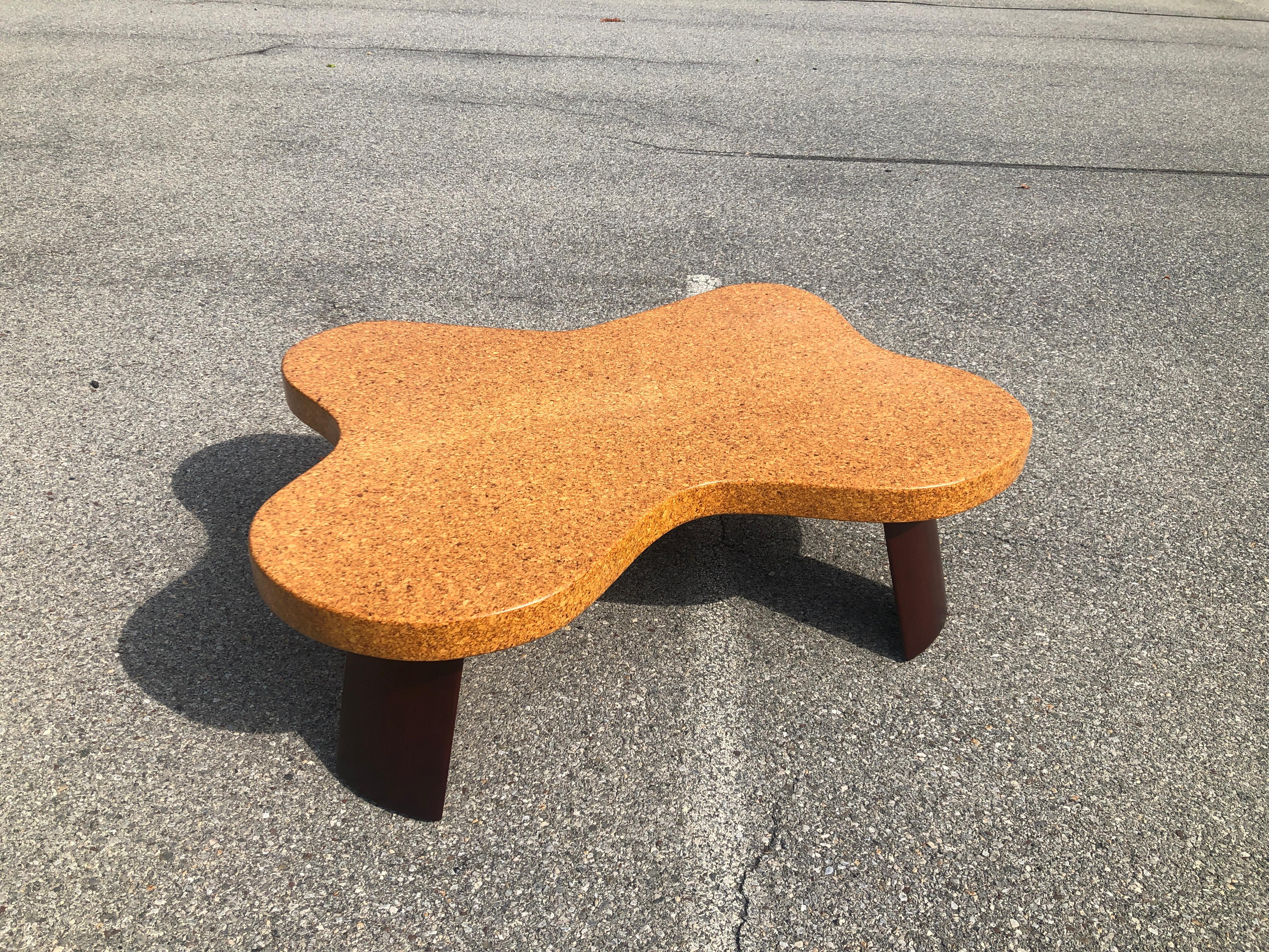 Morphic, signature Paul Frankl cloud coffee table model 5005 designed for Johnson Furniture Company, 1951. The table is in excellent condition with a natural waxed cork top and darkened mahogany legs. 100 percent restored surface near mint.
   