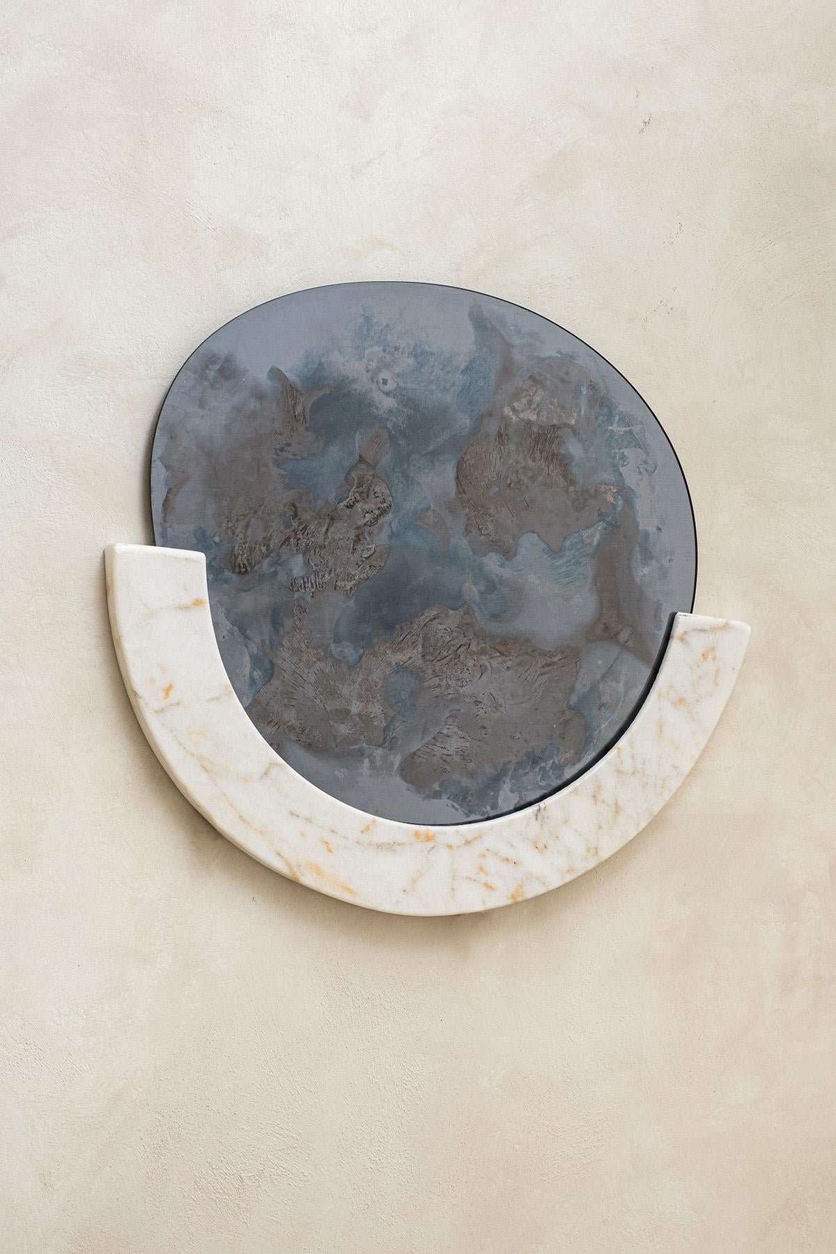 Cloud Mirror I by Homa
Dimensions: W 54 x D 60 x H 0.4 cm, 
Half Marble Frame: Ø 65 x 8 x 3 cm
Materials: Smoke and Silver Oxidized Mirror, Clear Glass. 

HOMA is a contemporary design atelier based in Istanbul. The atelier’s trademark processes are
