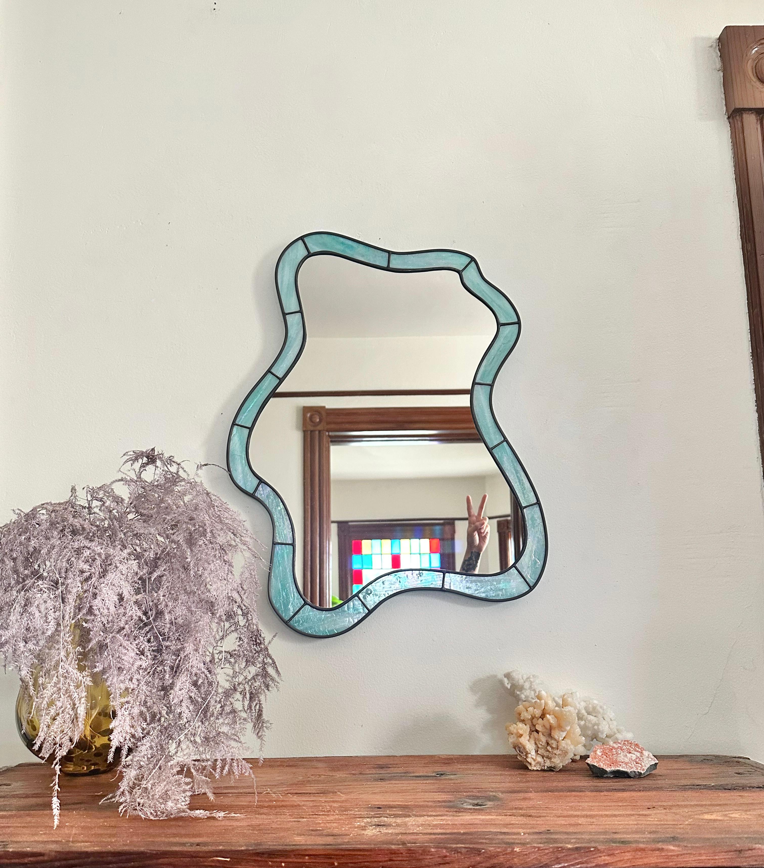 Made of one of a kind Iridescent  Turquoise  colored stained glass, the Cloud mirror glistens in any space it inhabits.

(This piece is made to order and due to the uniqueness of the glass, your piece will differ slightly from the photo)