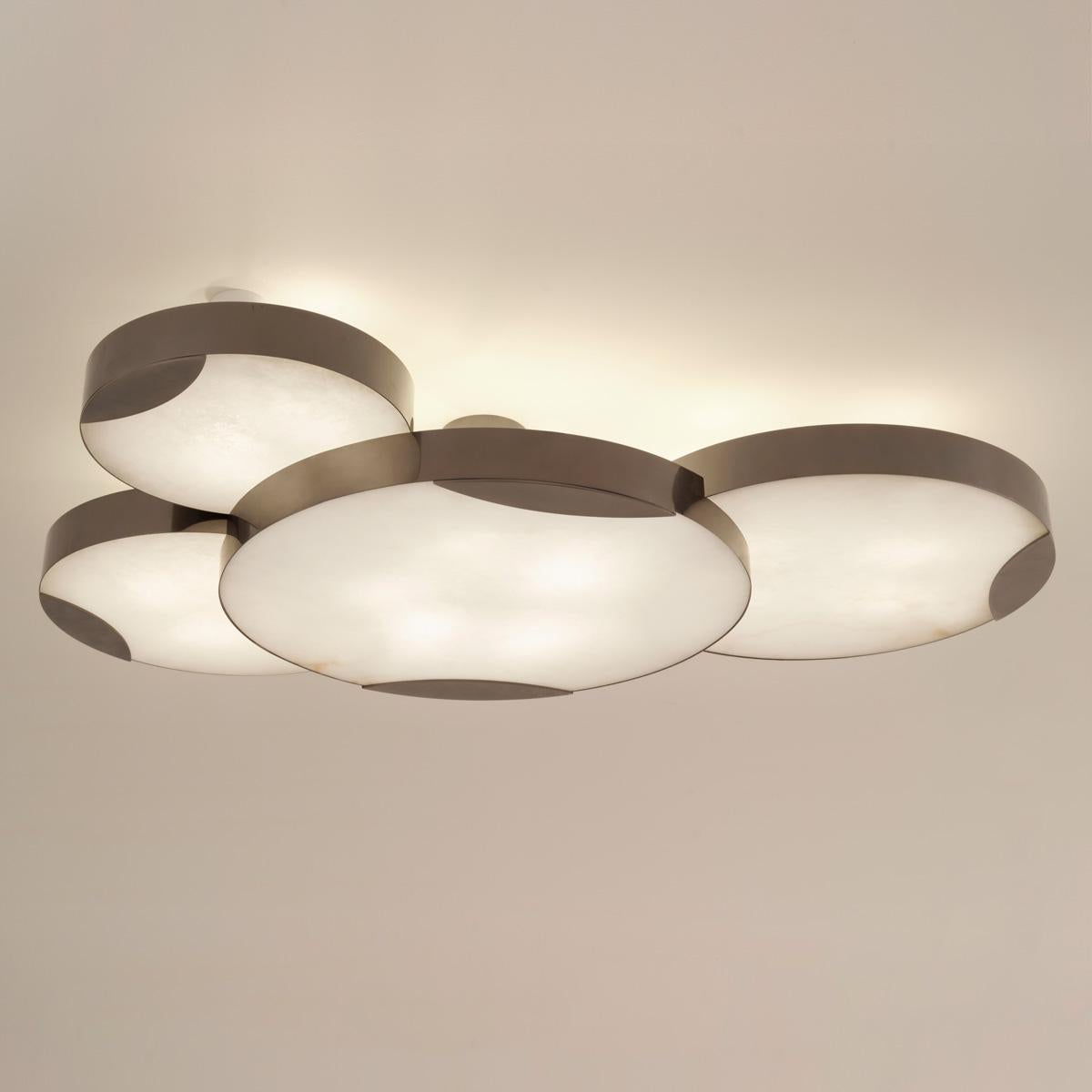 The Cloud N.4 ceiling light features four overlapping shades with large Tuscan alabaster diffusers providing an impressive amount of ambient light as well as up lighting. The shades are of different sizes as well as staggered, creating a highly