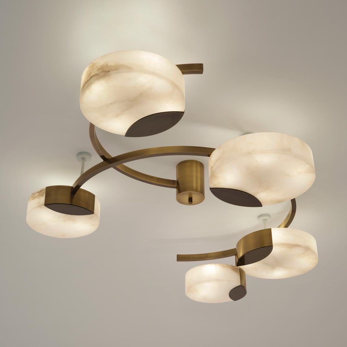 Intersecting semi circles and round alabaster shades come together in the Cloud N.5 ceiling light to create a piece that feels sculptural yet light and dynamic. The five shades are carved from a single block of Tuscan alabaster, from the town of