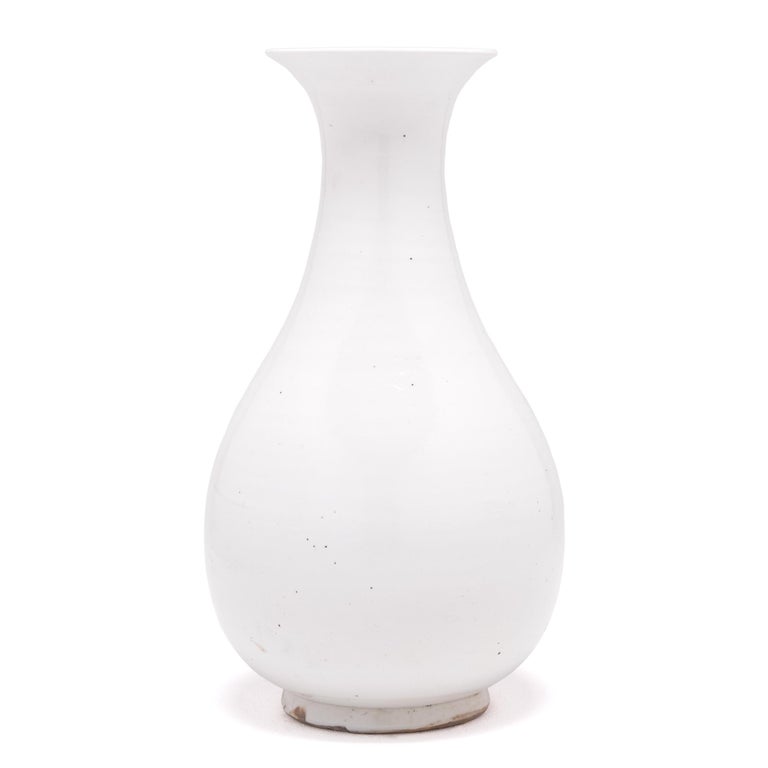Called a phoenix tail vase for its elegantly flared silhouette, this contemporary cloud-white vessel pays tribute to China’s mastery of the art of monochrome porcelain. Developed during the ancient Han dynasty and perfected over the centuries,