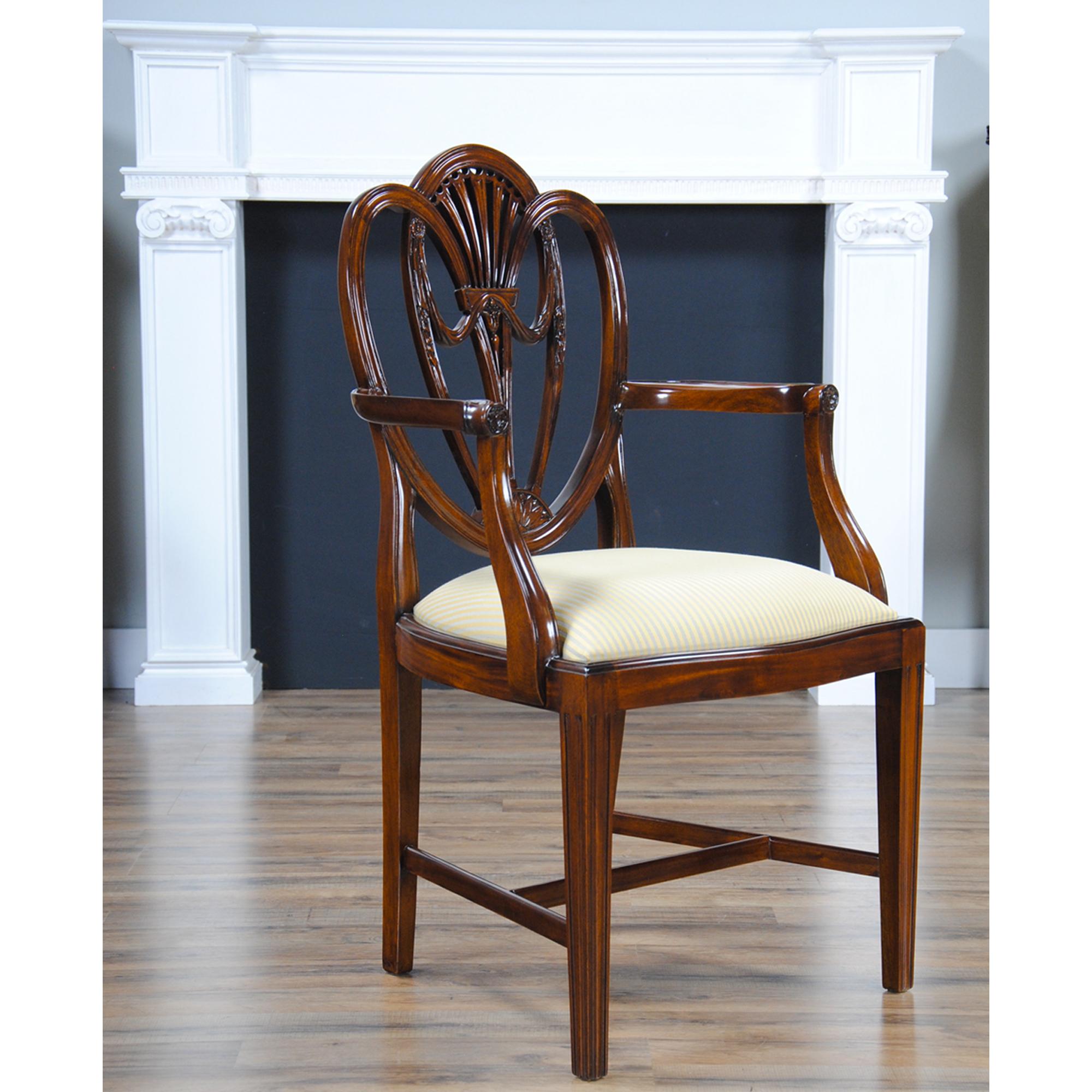 A set of ten fine quality Clover Back Dining Chairs, the set consisting of 2 arm chairs and 8 side chairs. The chairs have an elegant and stylish back featuring Drape Carvings as well as interconnected loops crested by a pierced back splat. Tapered