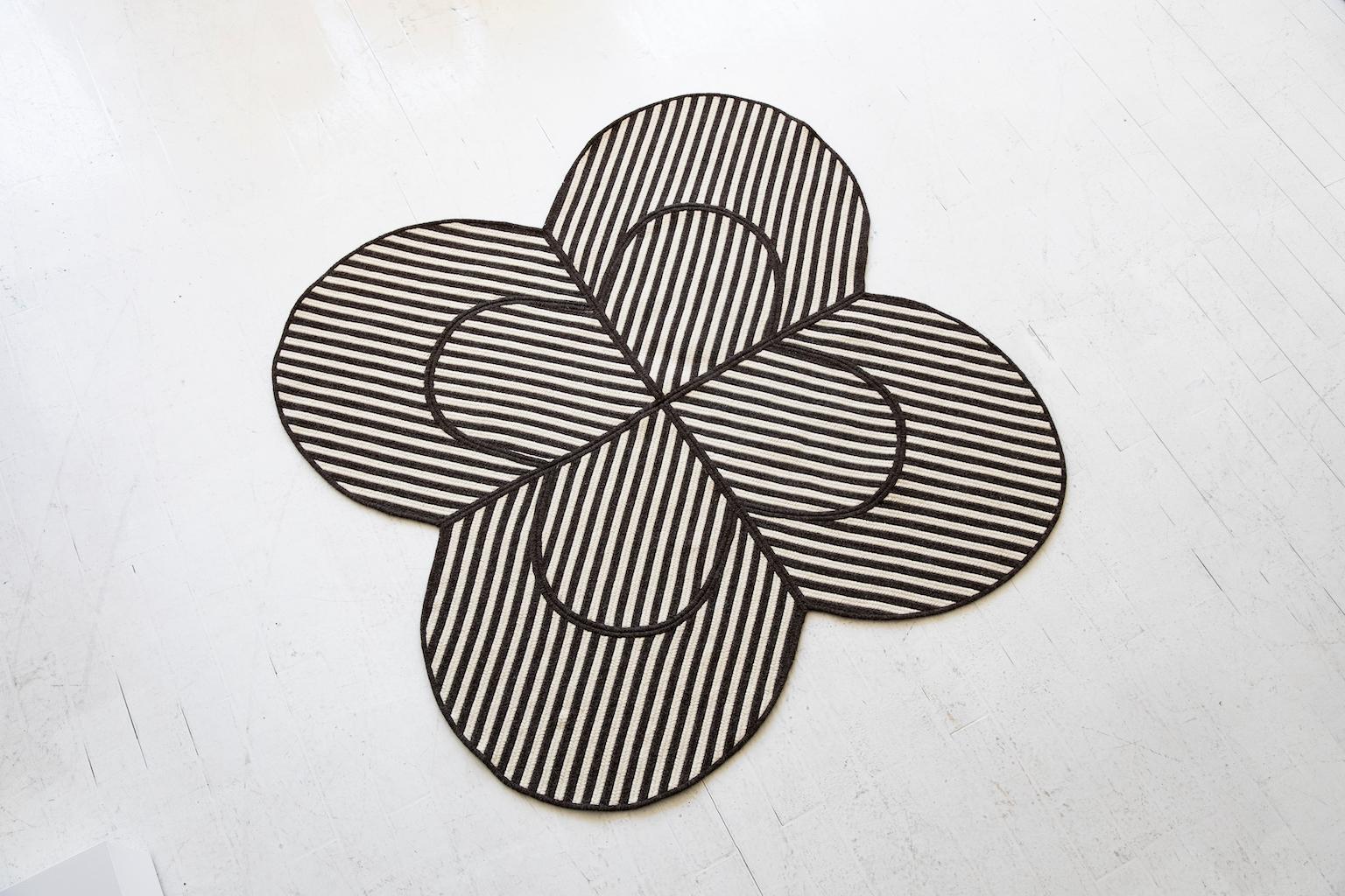 An iconic clover shape with a graphic composition of braided wool lines.

Handmade in New England by a mill with 30 years of manufacturing experience, each rug is braided and sewn to order using natural undyed Canadian wool.

Custom sizes,