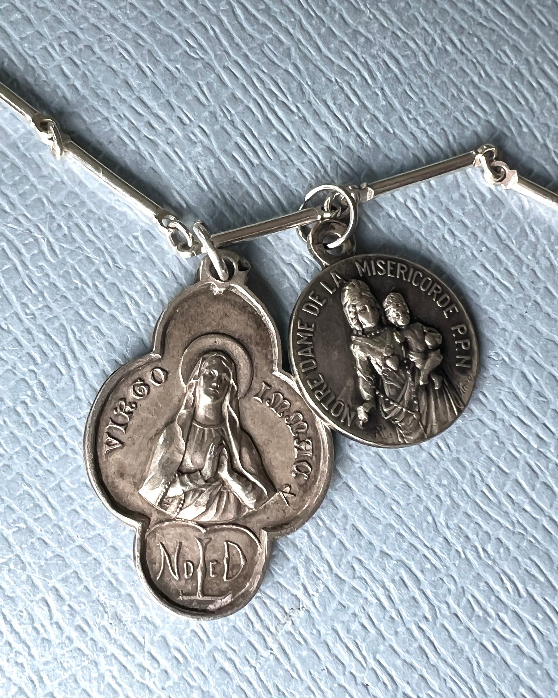 
Long Chain Necklace Miraculous Medal Virgo Oval Pendant
Virgin Mary Medal Clover Virgo Souvenir Lourdes, This is a Vintage Medal that is French. It has a second medal too that that has the text Notre Dame de la Misericorde. PPL

Silver Chain