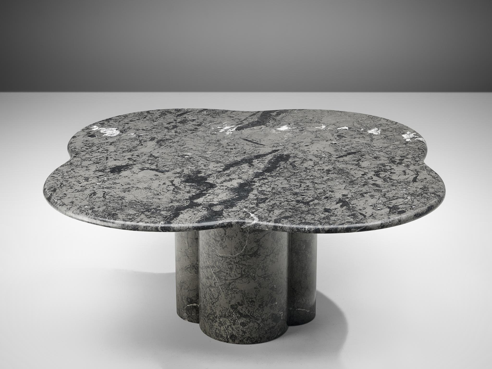 Coffee table, grey marble, Europe, 1970s.

A Postmodern cocktail table with a clover shaped tabletop with rounded edges. It shows a variety of marble veins in tones of grey, black and white. The biomorphic shaped top rests on a pedestal foot that