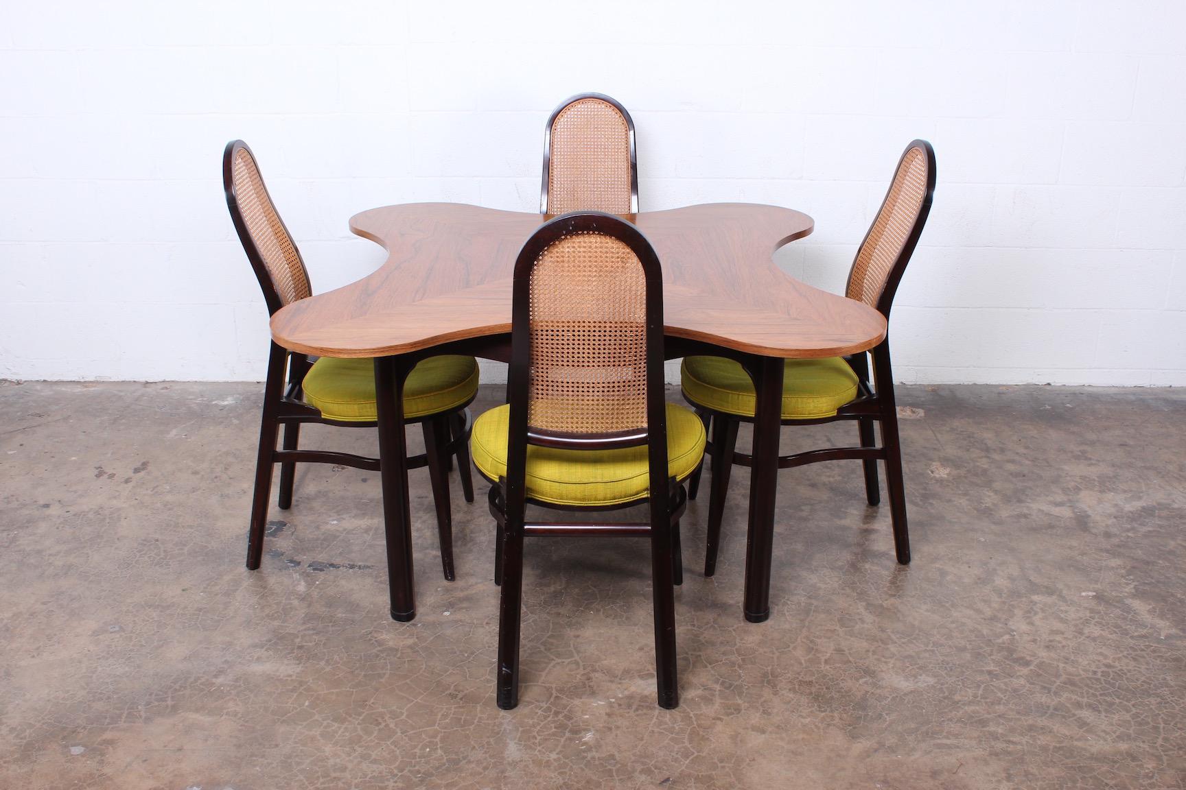 Rosewood and mahogany clover game table designed by Edward Wormley for Dunbar. 

Chairs available separately.