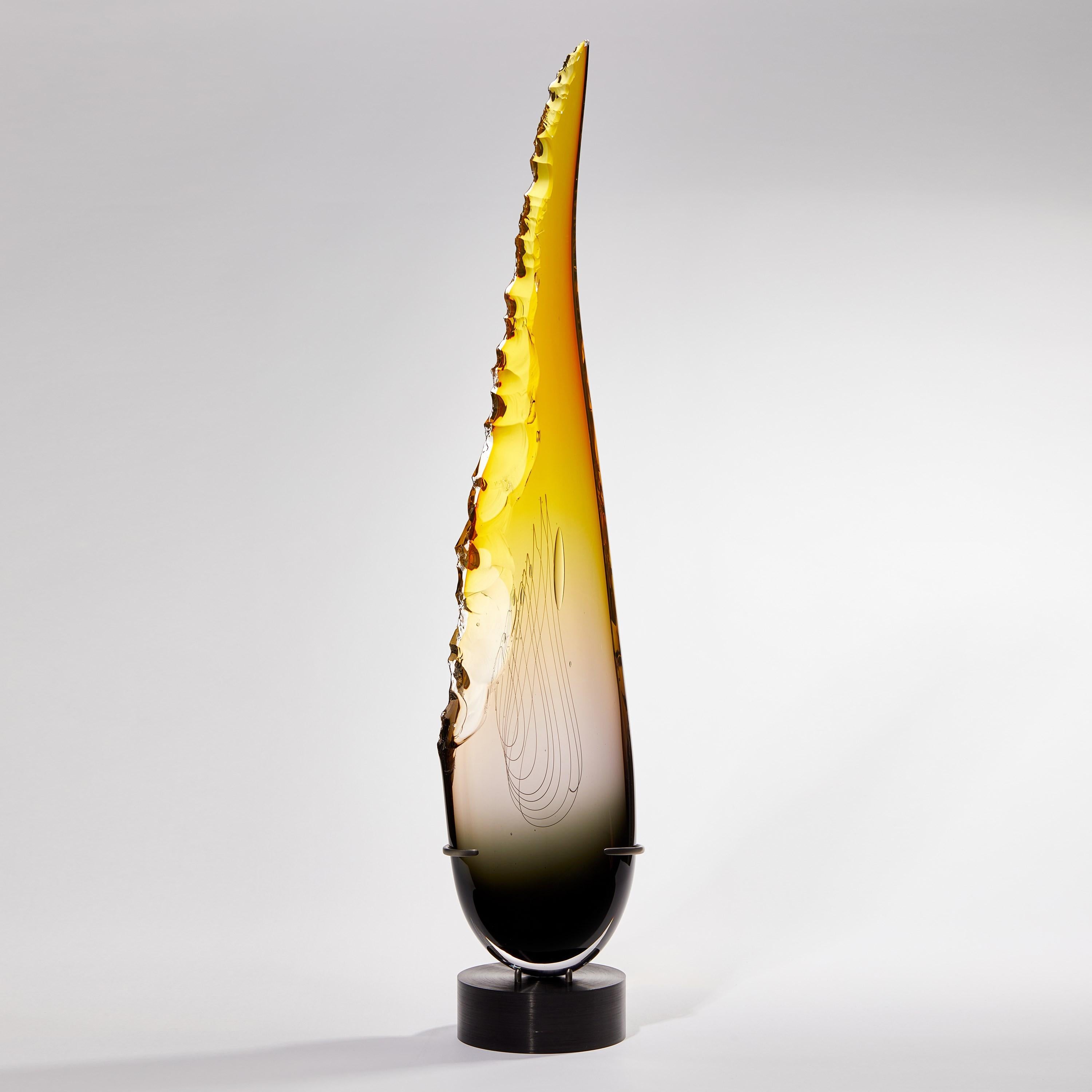 'Clovis in Grey to Topaz' is a unique tall glass sculpture by the British artist James Devereux.

Refinement and daring combine within this statuesque sculpture. Poised upon a museum-quality patinated steel base, the eye is drawn upwards, taken by