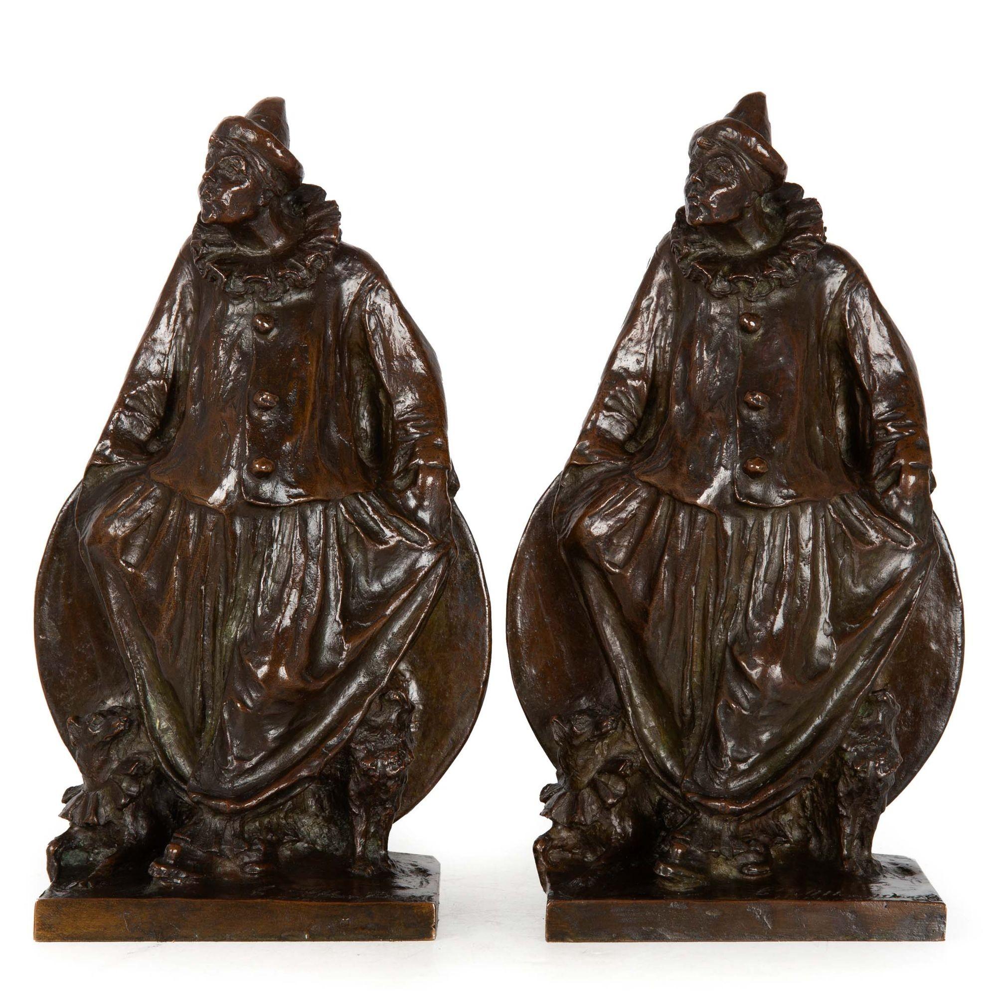 An exquisitely cast pair of Clowns, each depicted with a pair of dogs at their feet also dressed up for the show. These were conceived by Charles Humphriss in 1912 and were cast in pairs as bookends by Roman Bronze Works in New York for the