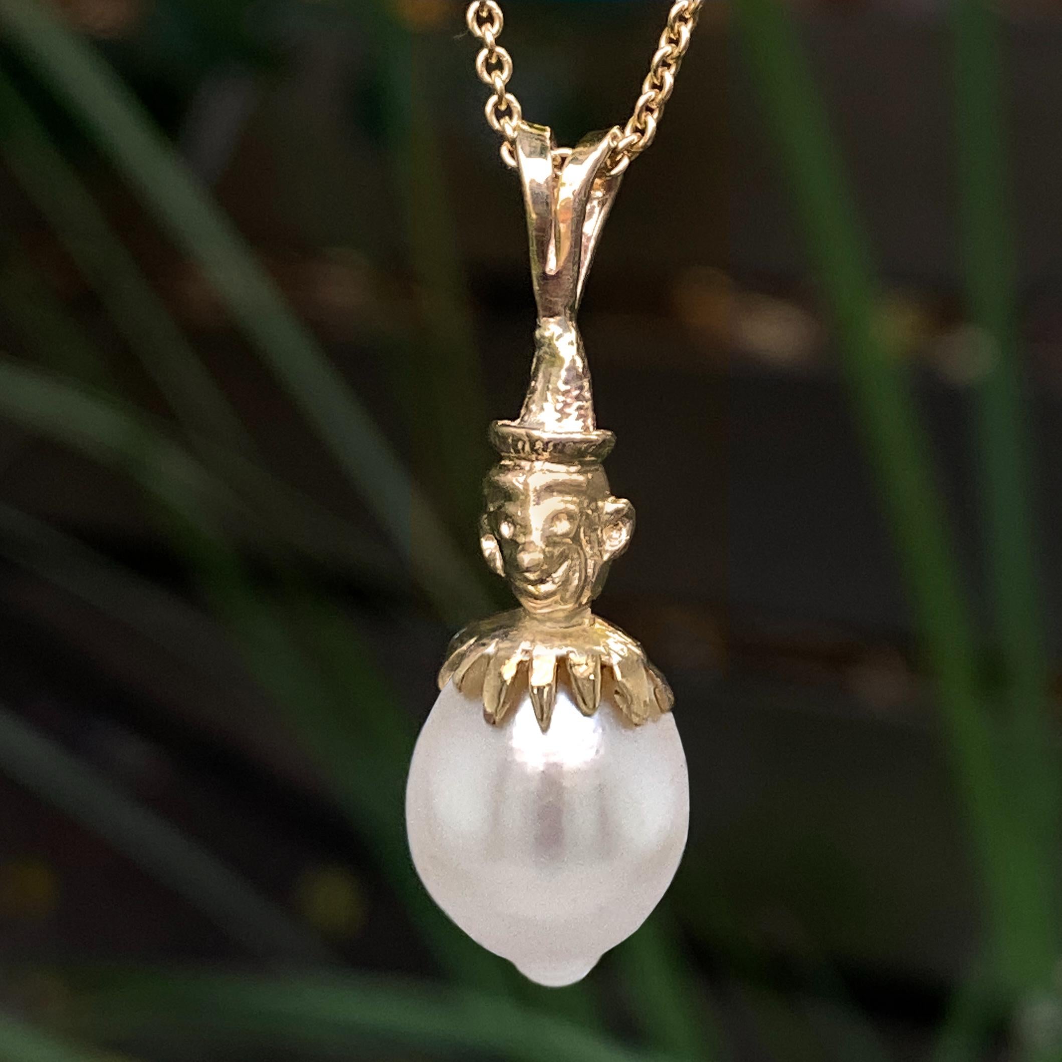 We found the perfect cap for this adorably dimpled baroque south sea pearl:  the top of a vintage articulated clown pendant!  

We had this pendant for a while, but it's frankly sort of creepy, and the world doesn't need any more creepy articulated