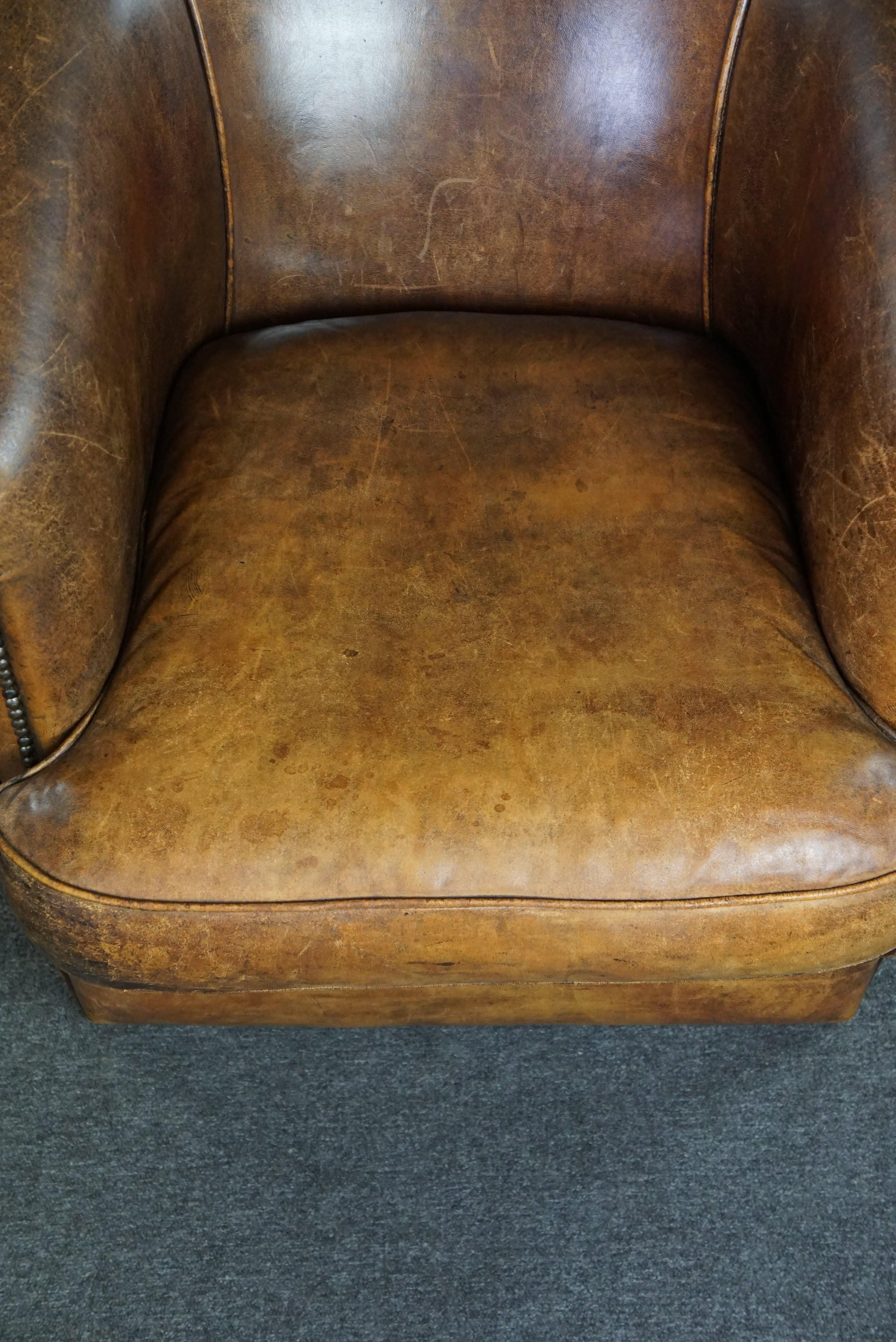 Leather Club armchair with patina, made of sheep leather For Sale