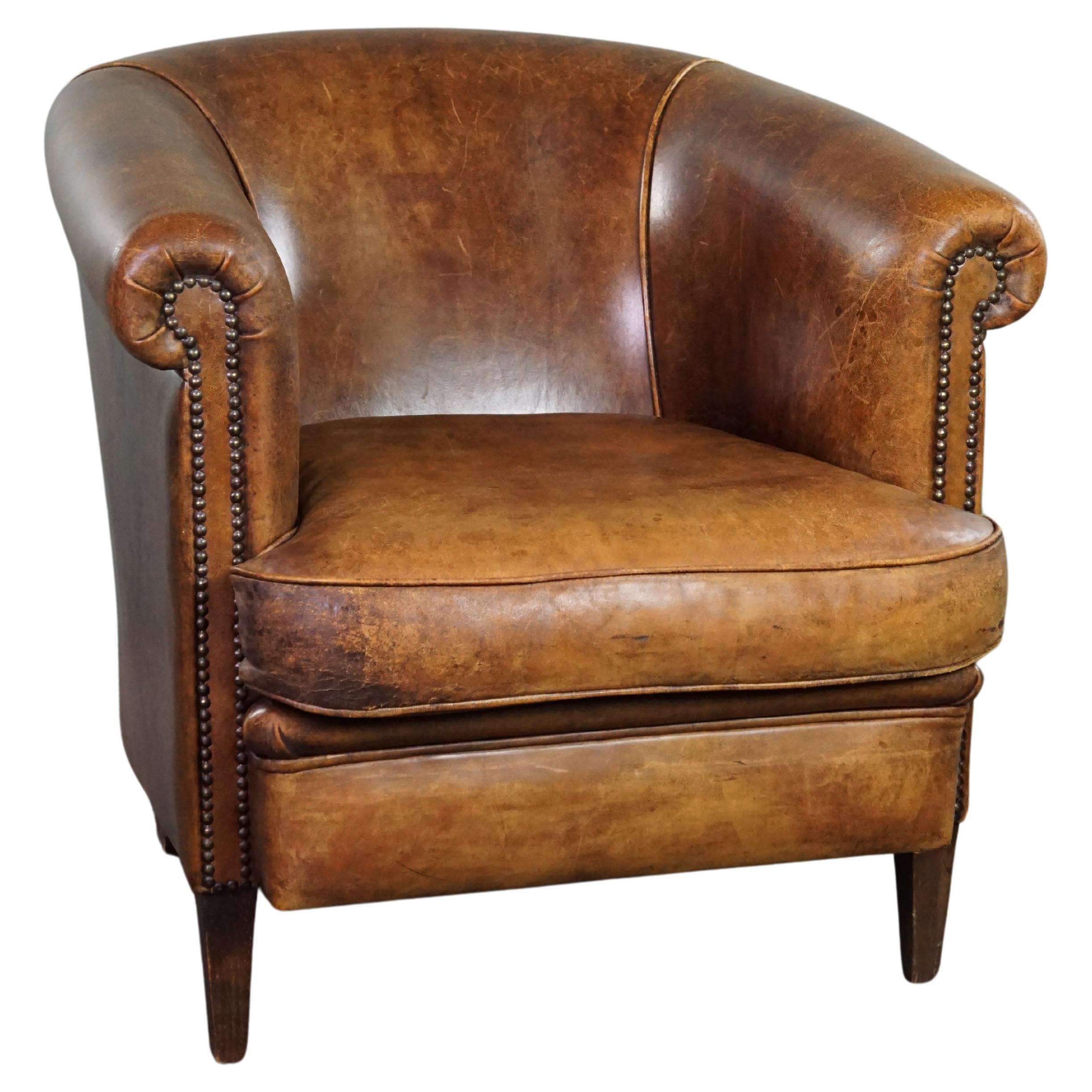 Club armchair with patina, made of sheep leather For Sale