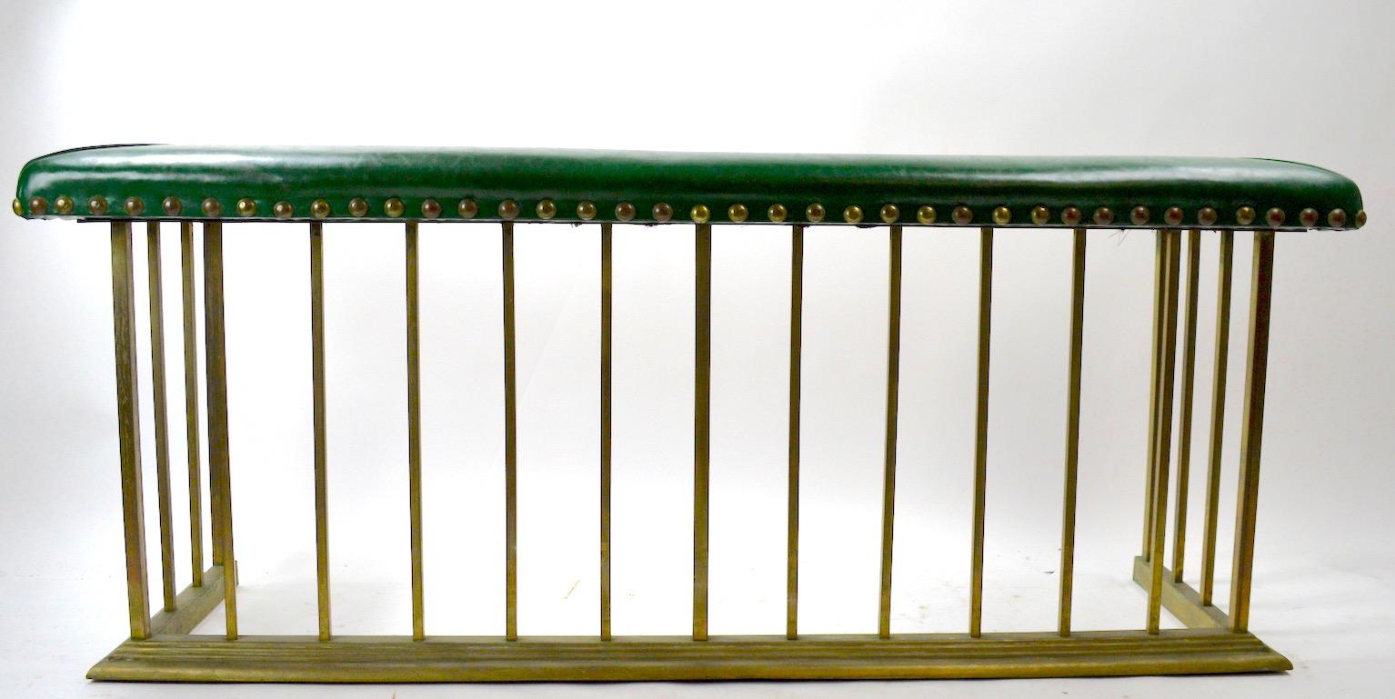 Nice tailored style club, Bench Fender, with upholstered (vinyl) seat and large brass stud nail heads. The body is brass with square stock and brass molding trim at the base. The brass finish is patinated, as expected from age and use. no structural