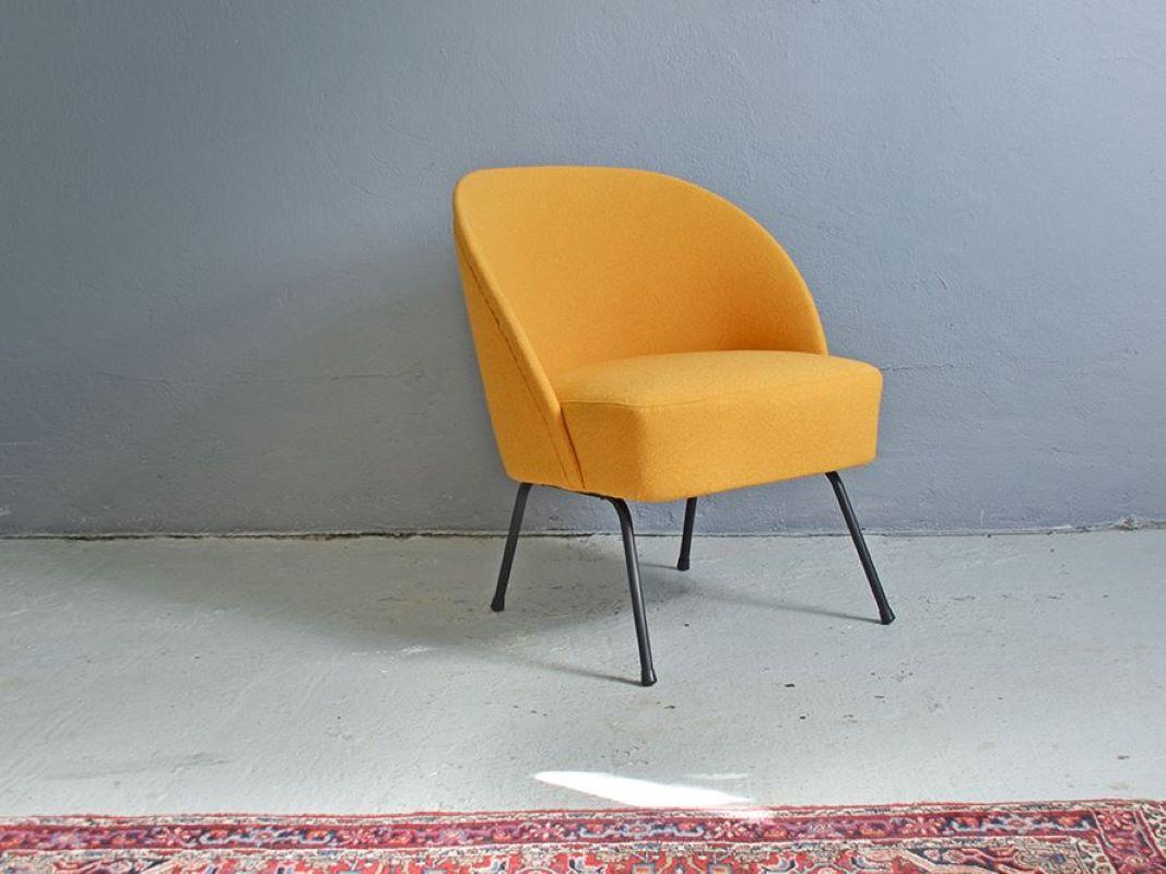 It is one of the version of 115 model designed by Theo Ruth for Artifort. It is the rare version on the metal frame. The chair was reupholstered. In the 1950s Theo Ruth became the manager of a team of new designers in Artifort. His designs gave a