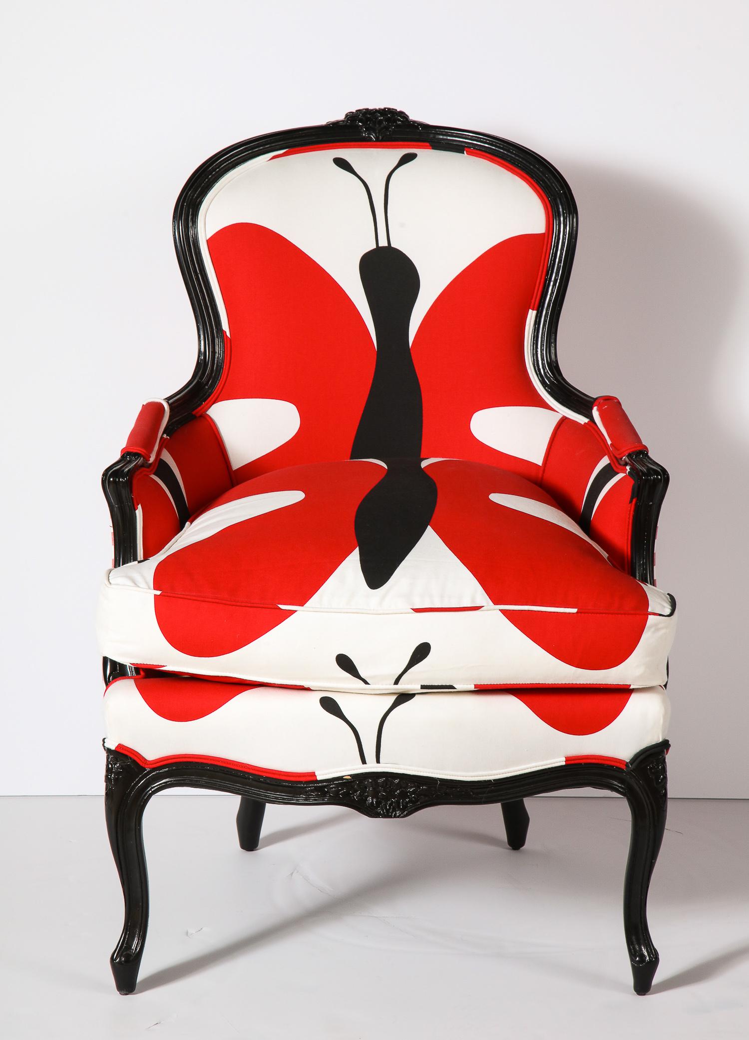 Decorative vintage Bergère chair designed in 100% cotton printed fabrics. Wood is black lacquer. Seat height is 18 inches. Seat cushion is filled with down.
The pictures are showing the arm rests in red fabric. It is now changed to the checker