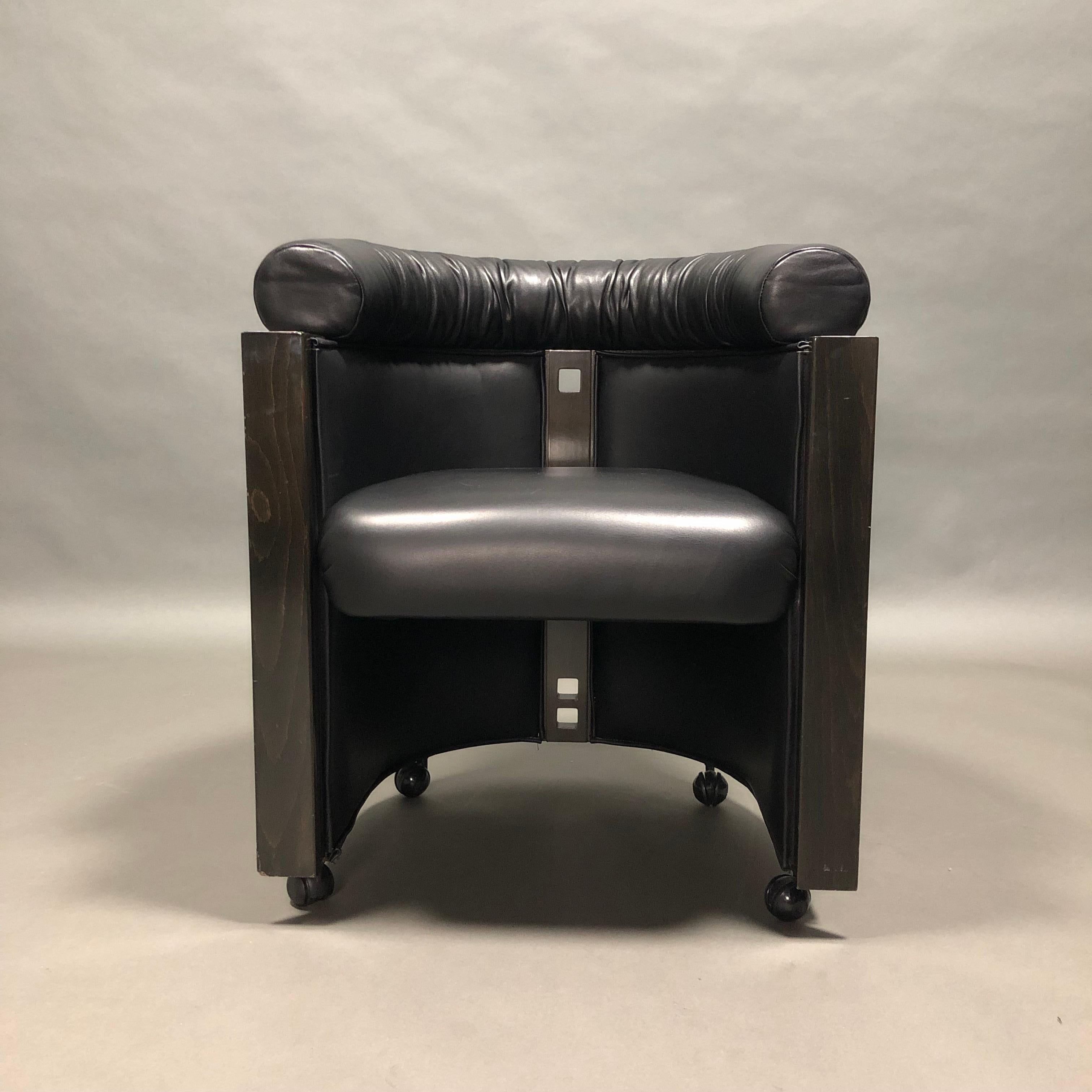 Elegant and very rare club chair by Umberto Asnago for Giorgetti, Italy, 1980s.

The chair is made of black leather and ebonized Oak. The back of the chair is also covered in leather. The base has four wheels.

Designer: Umberto