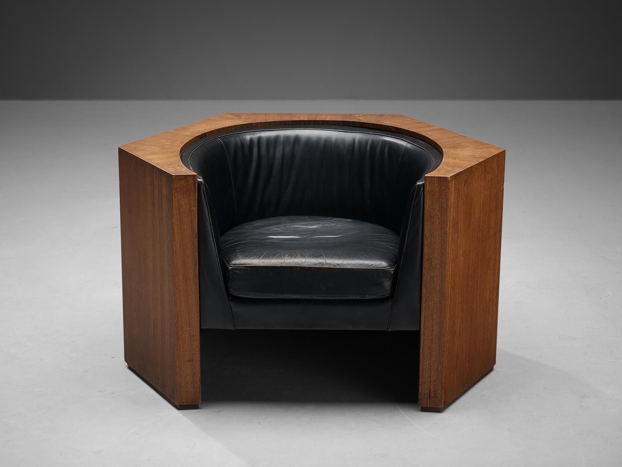 Club chair, leather, teak, Europe, 1980s.

This streamlined lounge chair is expressed by clear lines and pronounced geometric forms. The construction is based on a hexagonal shape that has an open layout at the front, revealing the 