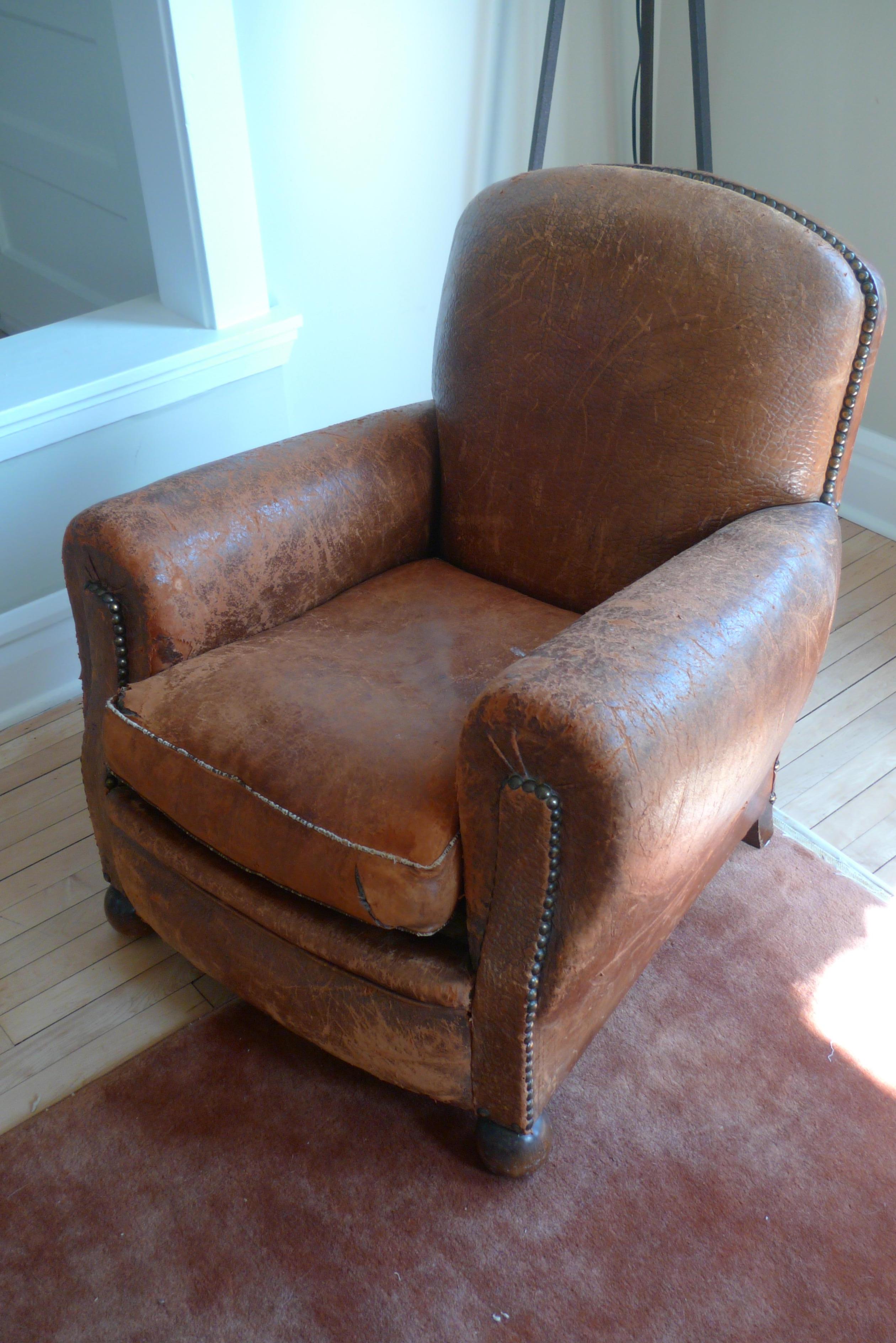 Club chair from Paris of alligatored leather, circa 1930s. All original material including the cushion stuffing and springs in the frame. Wonderful leather patina that only use and age can impart. With the feel and texture of a life well lived with