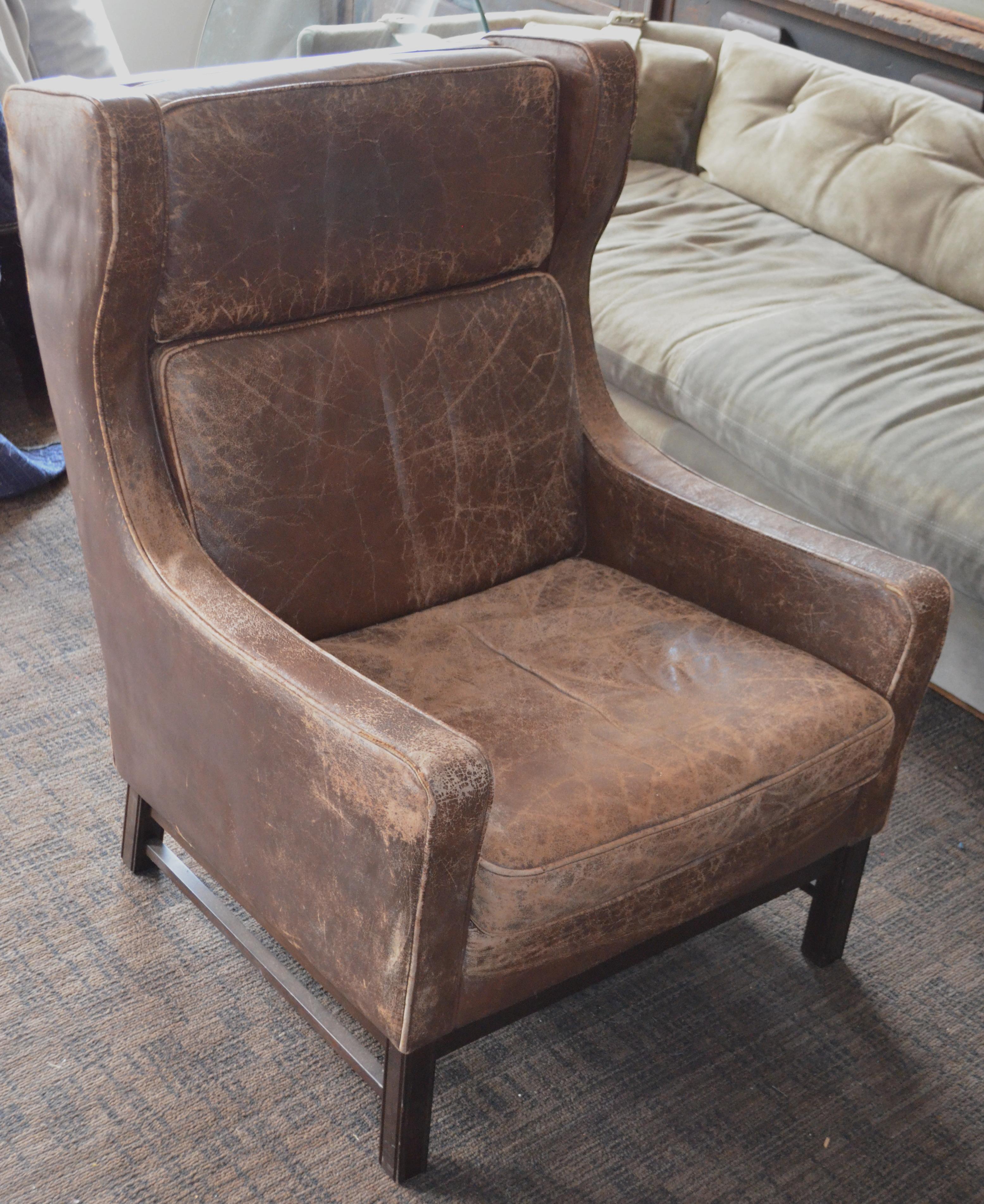English Club Chair of Worn Leather from Edwardian England, Wingback, Early 20th Century For Sale