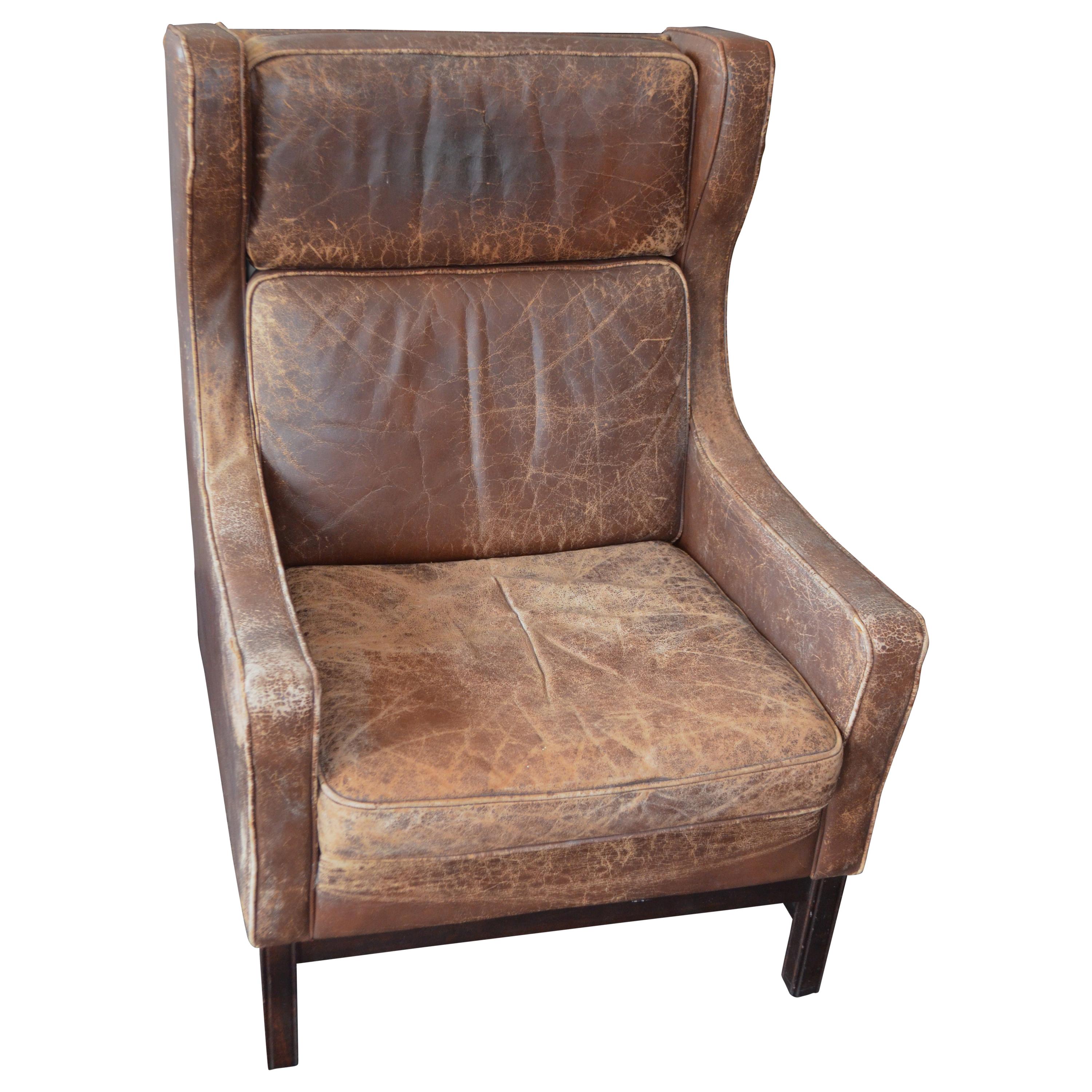 Club Chair of Worn Leather from Edwardian England, Wingback, Early 20th Century For Sale