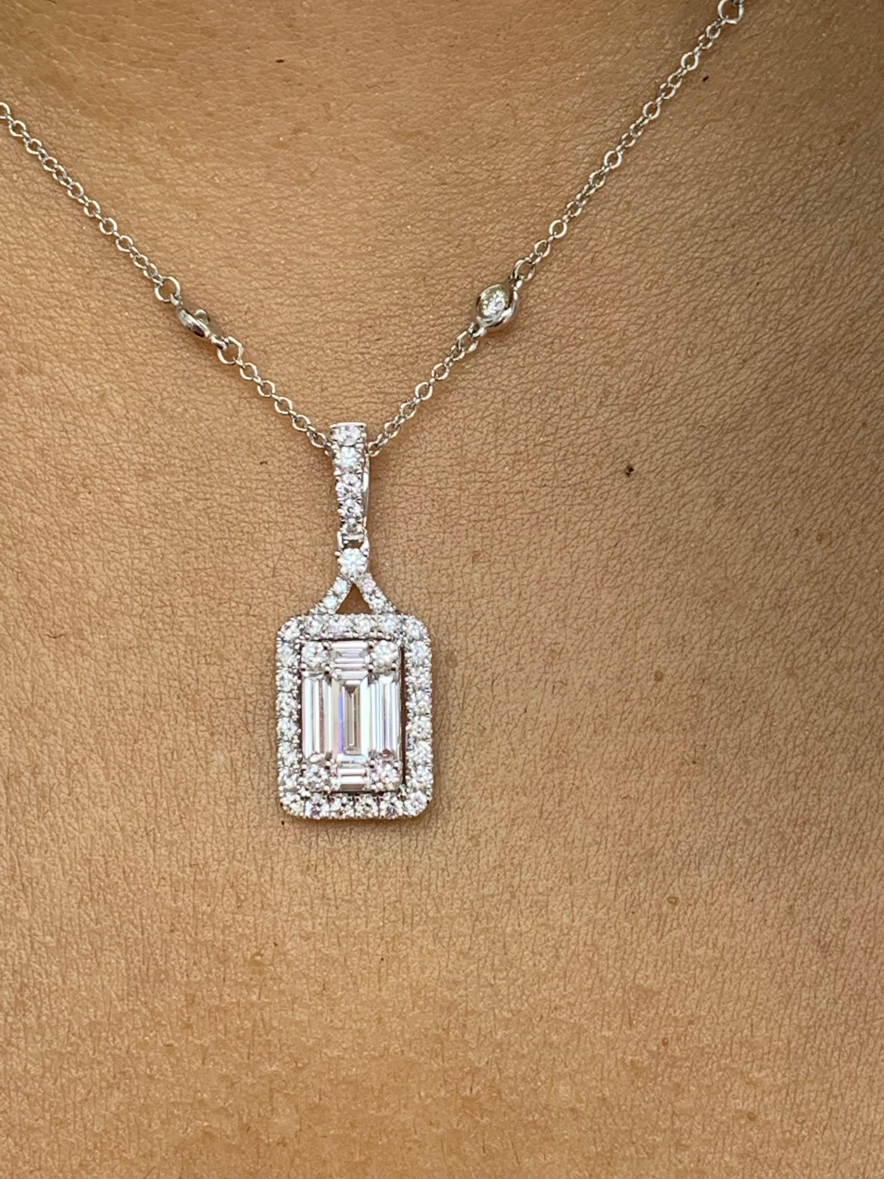 Showcasing a group of baguette diamonds set like an emerald cut diamond, surrounded by a row of round brilliant diamonds. Baguette diamonds weigh 0.69 carat in total . 38 Accent Diamonds weigh 0.62 carats total. Suspended on a 16-inch diamond by the