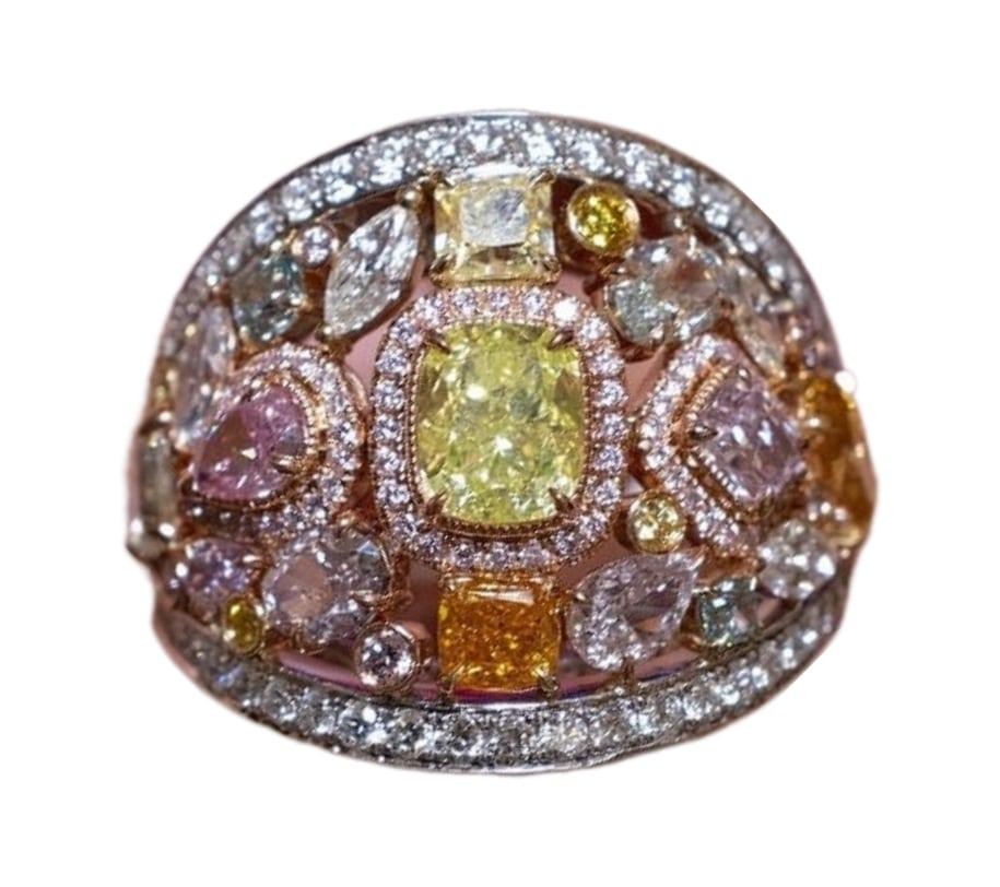 Each individual diamond was carefully selected by us with utmost care and discernment, ensuring their perfect alignment within this exquisite ring.

This one-of-a-kind array of fancy colored diamonds come in all shapes, sizes and of course