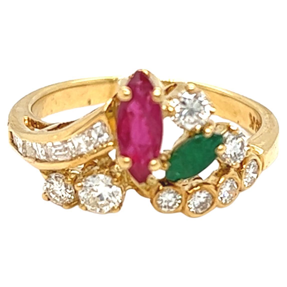 From our estate jewelry collection, this handcrafted 18k yellow gold cluster gemstone and diamond ring features a marquise shaped ruby and emerald and mixed cut diamonds. The total weight of diamond is approximately 1 carat with G color and VS1-2